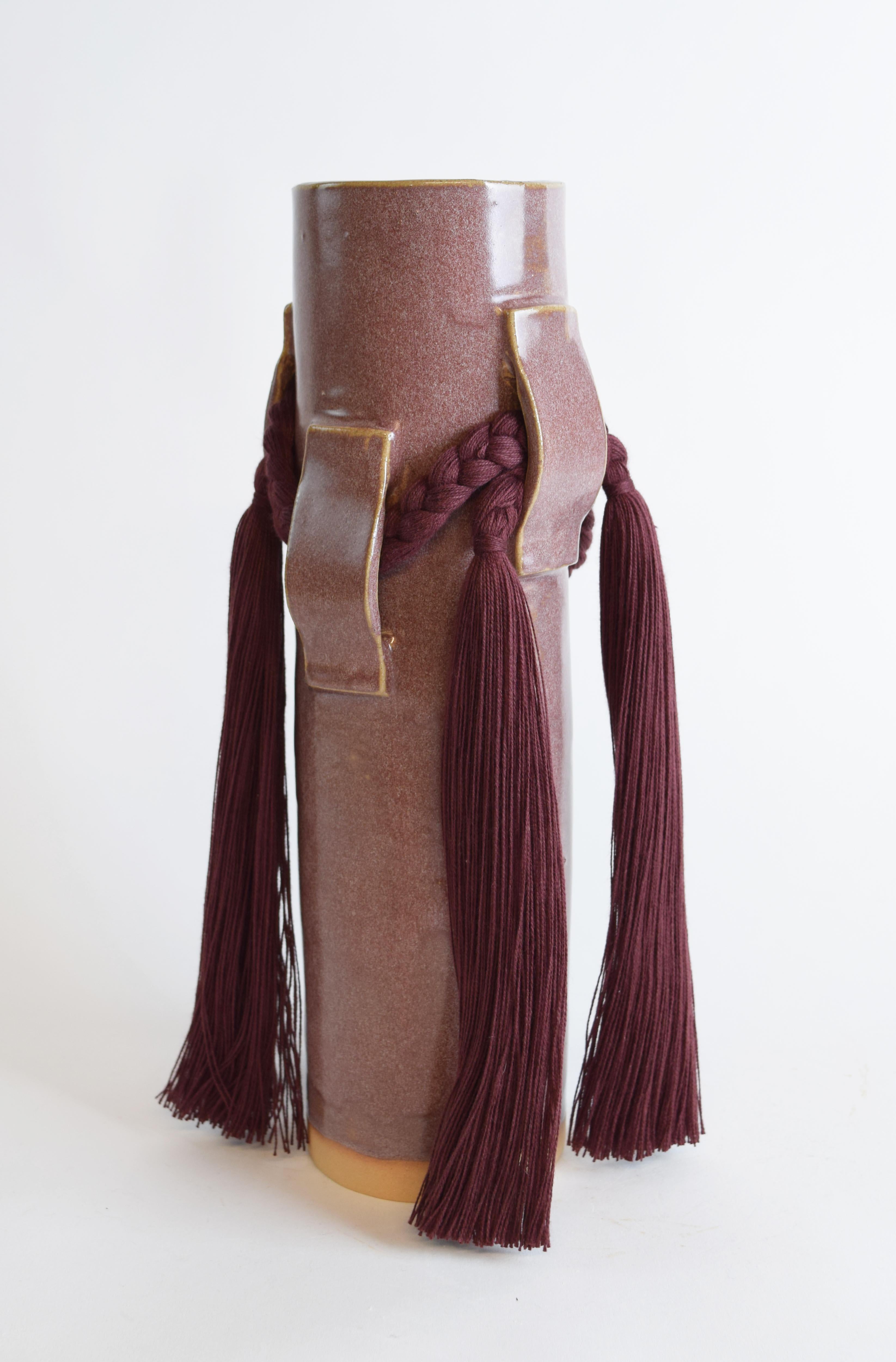 Vase #800 by Karen Gayle Tinney

Hand formed stoneware with burgundy glaze. Burgundy cotton braided details. Inside is glazed, the vessel will hold water.

13”H x 5”W

Karen Gayle Tinney is an artist and designer whose work consists of pieces that