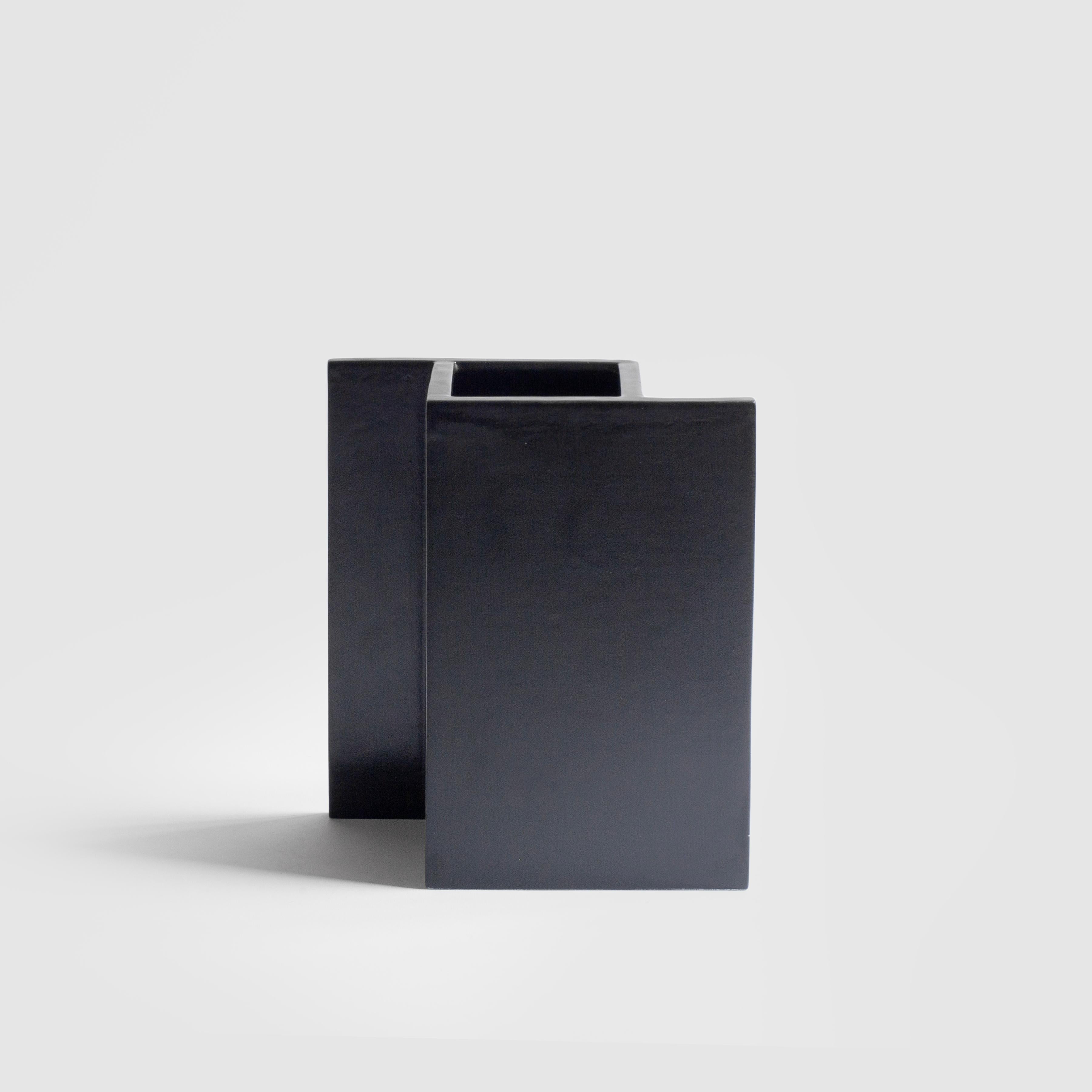 A minimalist and playful vase in slip-cast ceramic with a black matt glaze, the piece is handmade in Milan.
Part of the 
