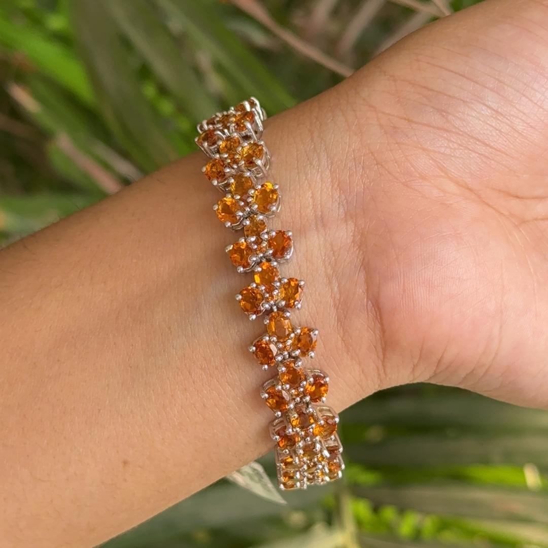 Handmade Citrine Cocktail Tennis Bracelet in sterling silver showcases endlessly sparkling natural citrine, weighing 38.03 carat. It measures 7 inches long in length.
Citrine stimulate concentration and reduces stress. 
Designed with perfect oval
