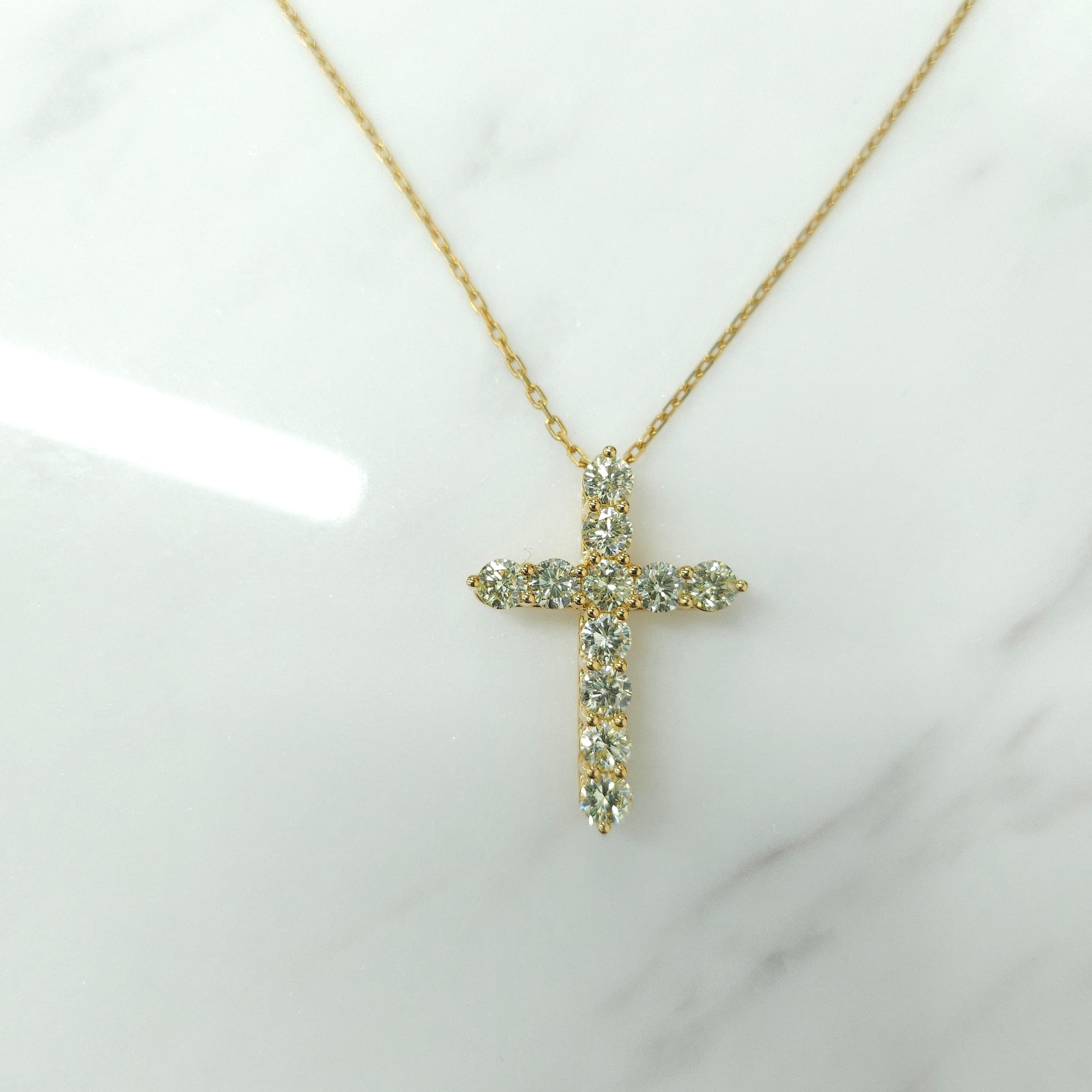 A precious interpretation of a classic motif, our cross pendant in 18K yellow gold is available in a variety of different carat weights, seen here with 0.14 carat diamonds. Deftly suspended from a gold chain, each diamond is embraced by a minimal