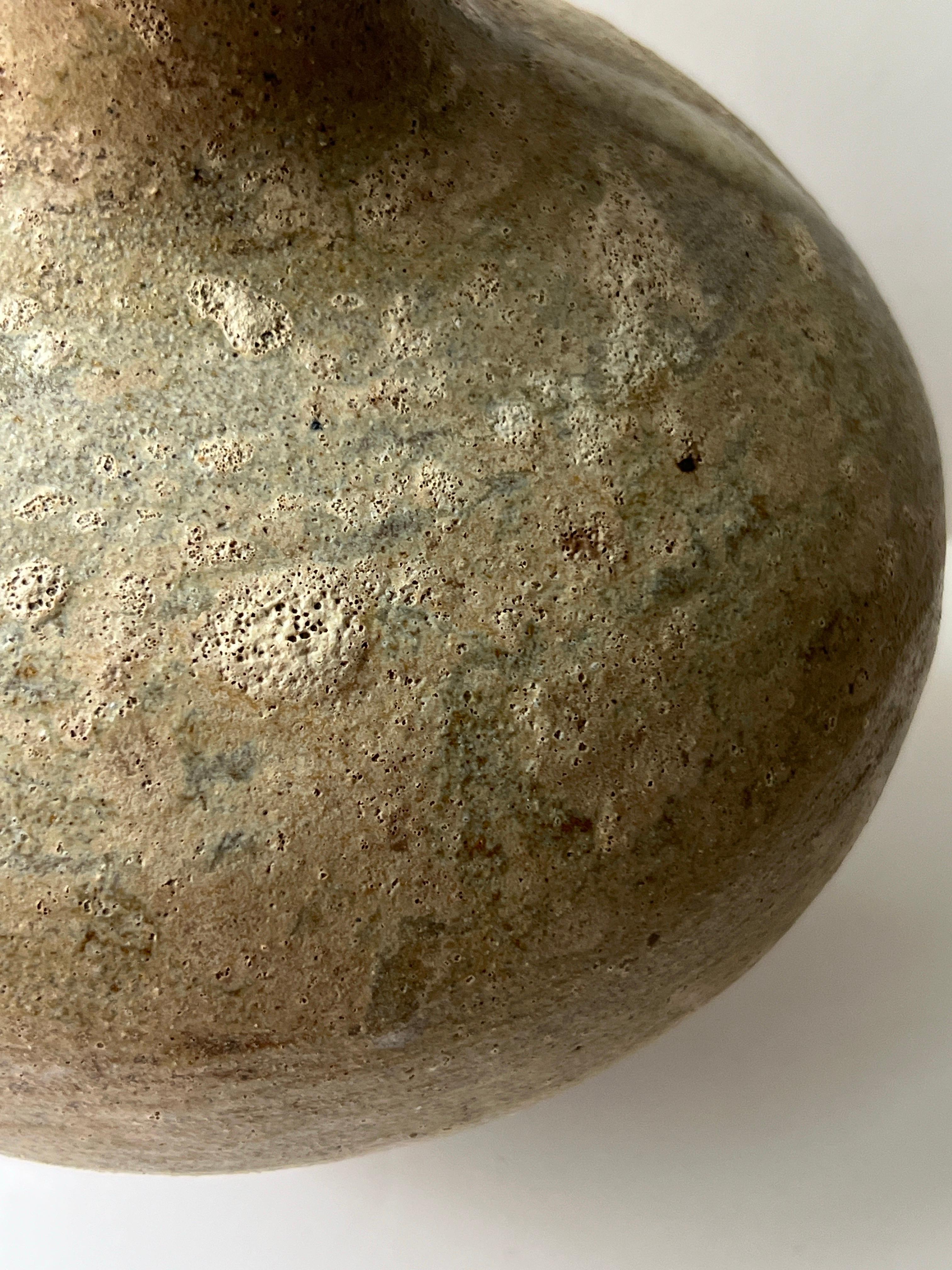 This Ember Vessel embodies the essence of a mountain sunset, where the sky blazes with color. Created through a delicate balance of ash glazes,the surface showcases rich, earthy tones with an experimental silhouette that highlights the natural