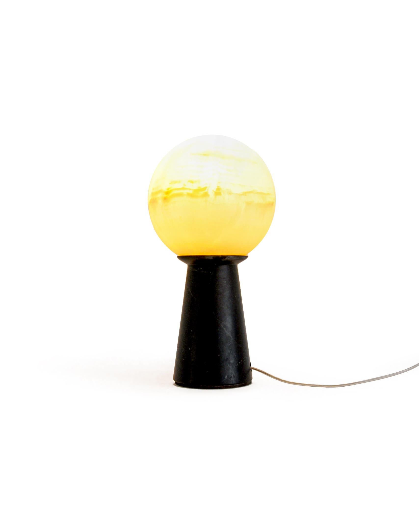 Conical lamp with sphere in satin white Carrara and black Marquina marble. It gives a distinct and elegant touch to your house.

Each piece is in a way unique (every marble block is different in veins and shades) and handmade by Italian artisans