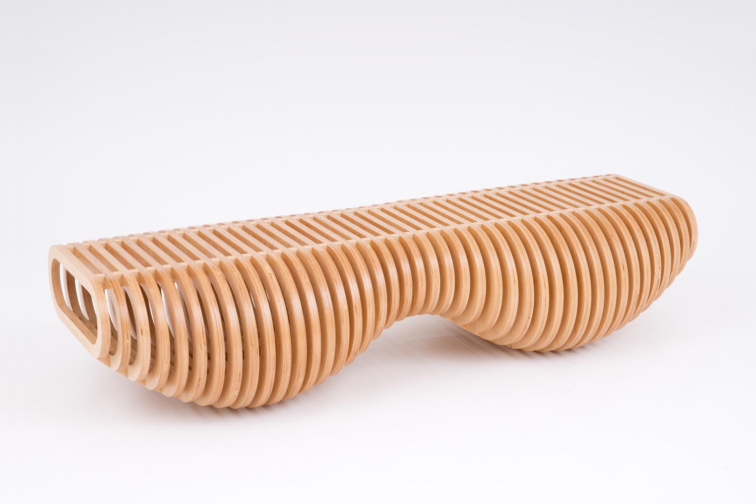 The organic shape of this bench / table / recliner is the result of clever mathematics. The rings are serial, concentric hoops, like the layers of an onion, cut with CNC technology from less than 3.4 m2 of the highest furniture-grade plywood. The
