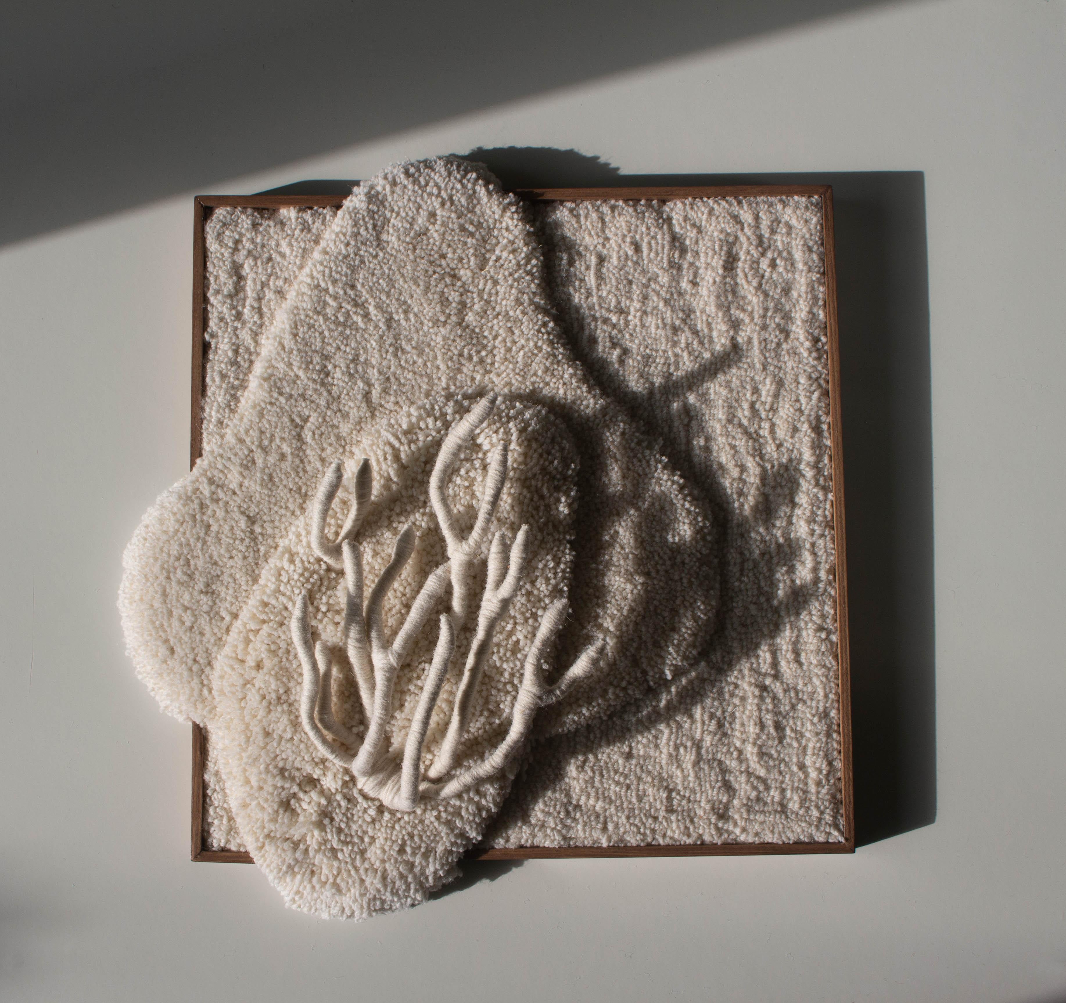 Bleached Anthozoa Tapestry is handmade with 100% Portuguese wool yarn, using tufting gun, carving and textile sculpture techniques. It has a 3D sculpture element and the pine frame, as part of the composition, is designed and produced by the studio.