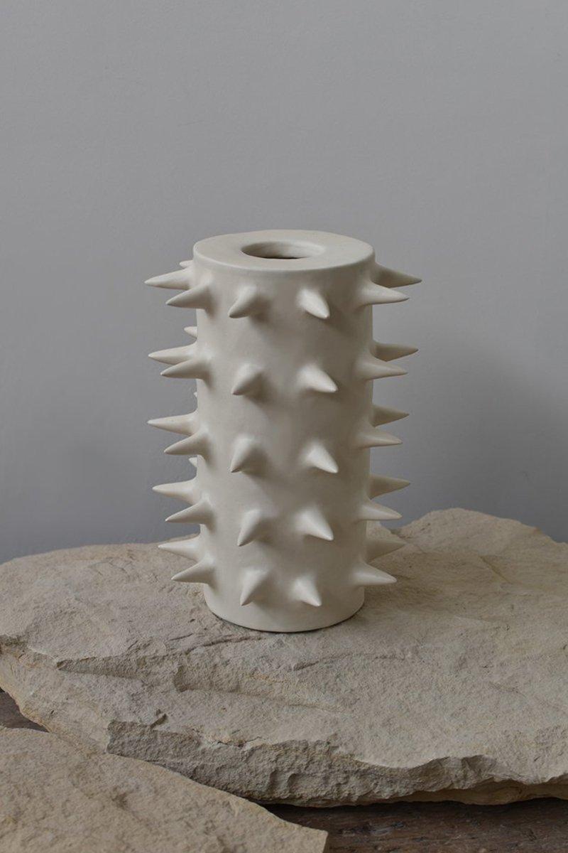 Beautiful tall white ceramic vase with spikes, perfect for showcasing your cherished blooms. Providing a unique perspective from every angle, this handmade pottery vase blurs the line between functionality and ornament. Use it either as a fully