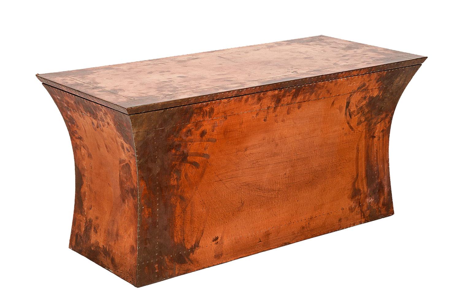 Handmade copper Vaisseau Bench By Stephanie Odegard.

This bench is handmade and has a solid teakwood frame that is clad in bronze and is part of the Stephanie Odegard Collection. Made for use, this functional piece is great for storage with