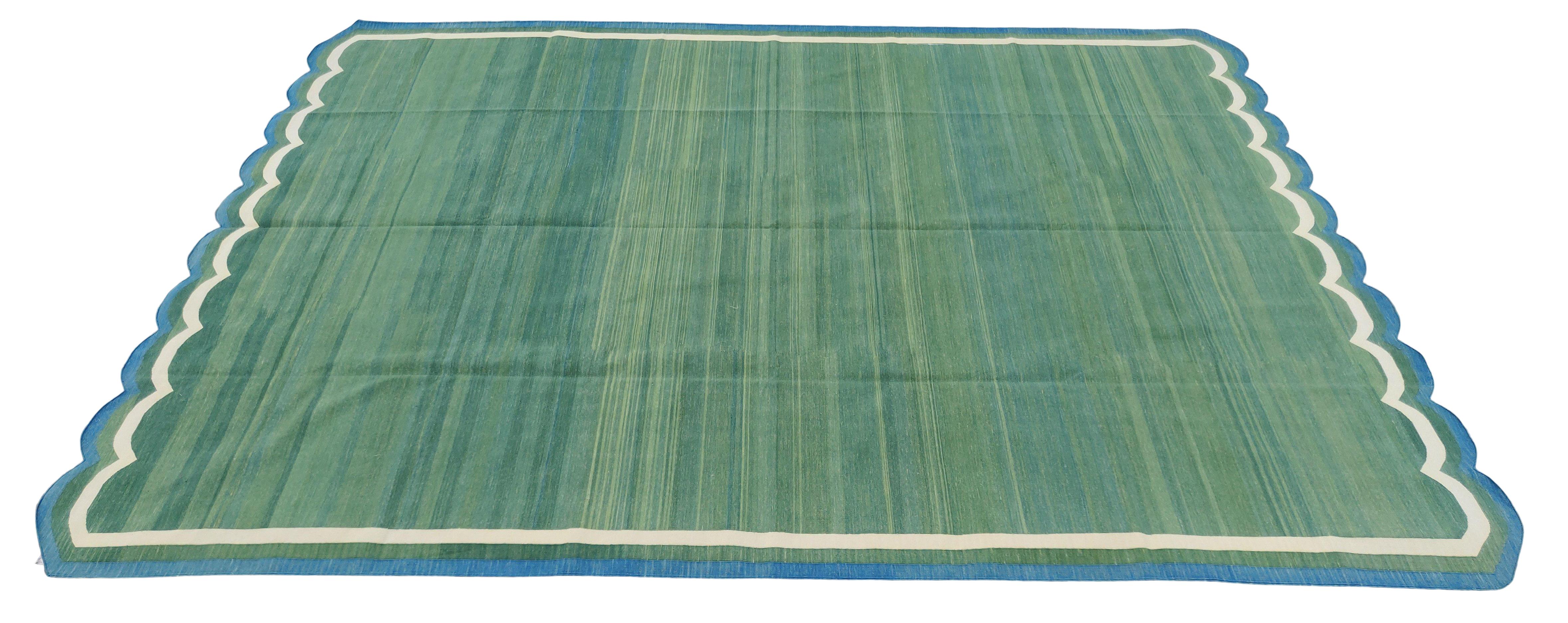 Cotton Vegetable Dyed Forest Green, Cream And Teal Blue Two Sided Scalloped Rug-10'x14' 
(Scallops runs on all 10 Feet Sides)
These special flat-weave dhurries are hand-woven with 15 ply 100% cotton yarn. Due to the special manufacturing techniques