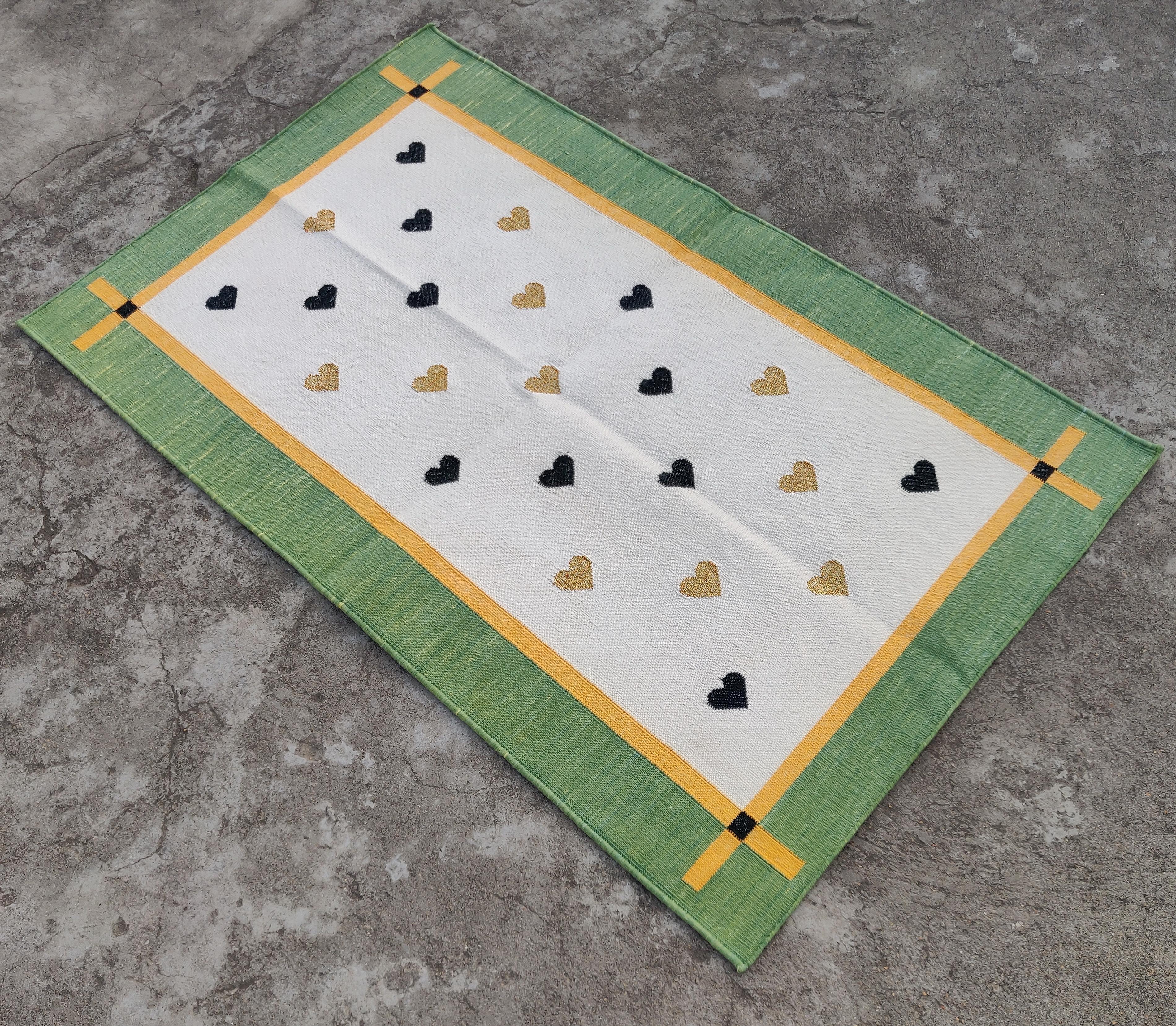 Cotton Vegetable Dyed Cream, Yellow And Green Heart Pattern Indian Dhurrie Rug-2.5'x4'
 
These special flat-weave dhurries are hand-woven with 15 ply 100% cotton yarn. Due to the special manufacturing techniques used to create our rugs, the size and