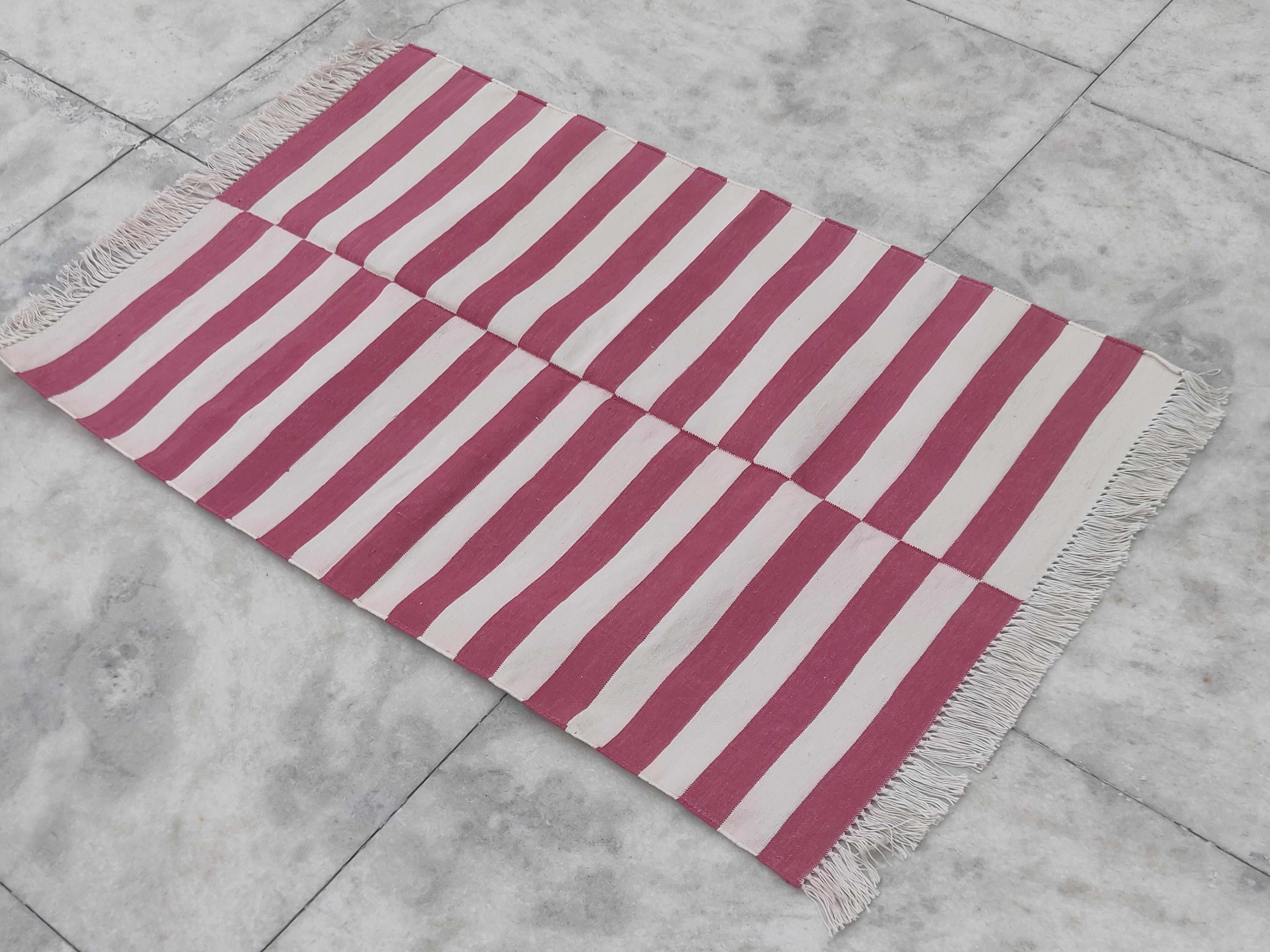 Cotton Vegetable Dyed  Pink And White Striped Indian Dhurrie Rug - 2.5'x4' (75x120cm) 

These special flat-weave dhurries are hand-woven with 15 ply 100% cotton yarn. Due to the special manufacturing techniques used to create our rugs, the size and