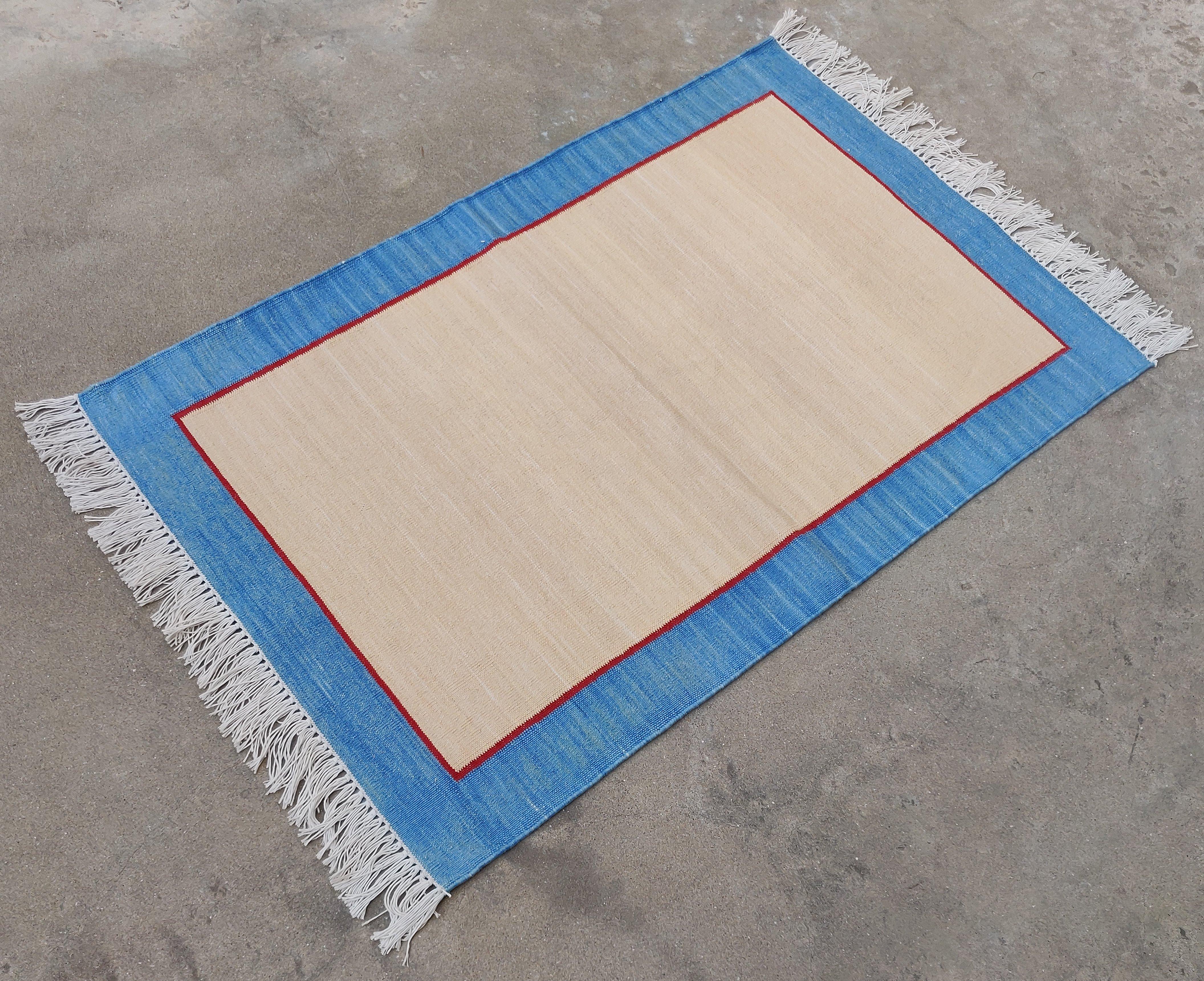 Cotton Vegetable Dyed  Beige And Blue Bordered Indian Dhurrie Rug - 2'x3' (60x90cm) 

These special flat-weave dhurries are hand-woven with 15 ply 100% cotton yarn. Due to the special manufacturing techniques used to create our rugs, the size and