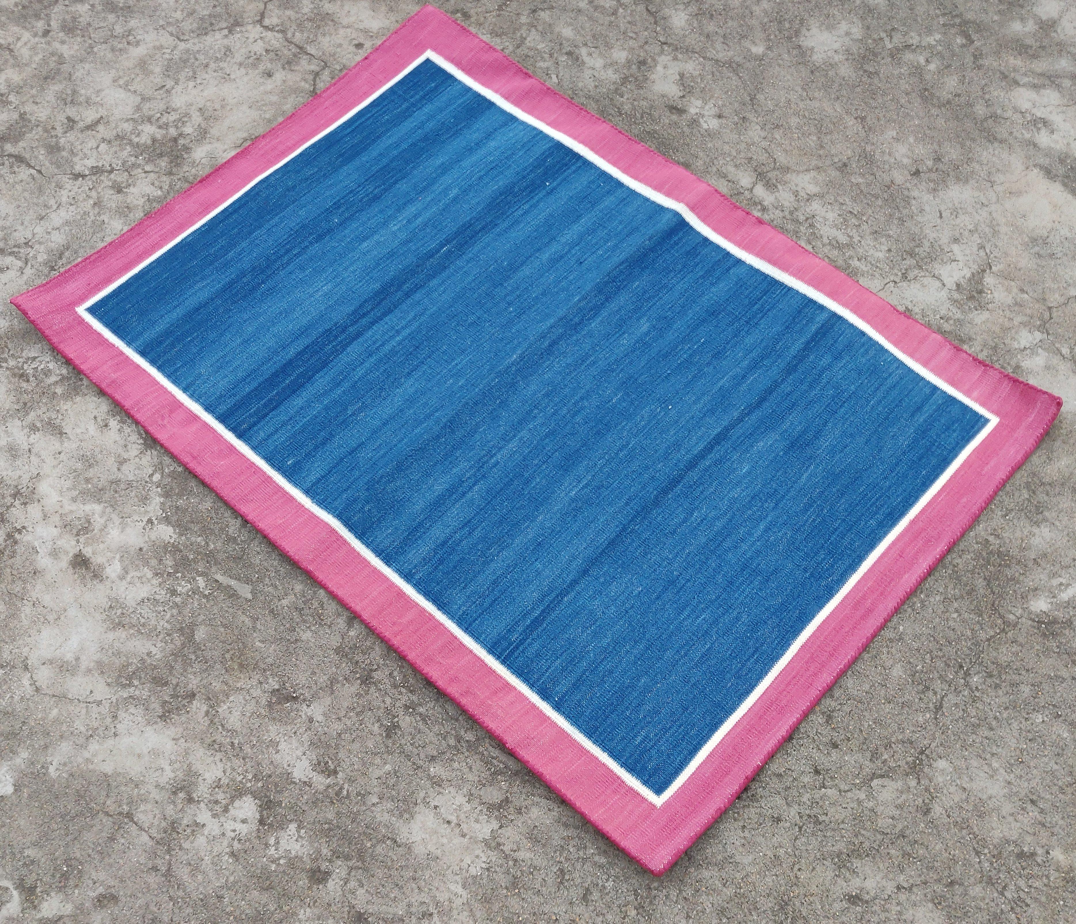 Cotton Vegetable Dyed  Indigo Blue, Cream And Raspberry Pink Bordered Indian Dhurrie Rug - 2'x3' (60x90cm) 

These special flat-weave dhurries are hand-woven with 15 ply 100% cotton yarn. Due to the special manufacturing techniques used to create