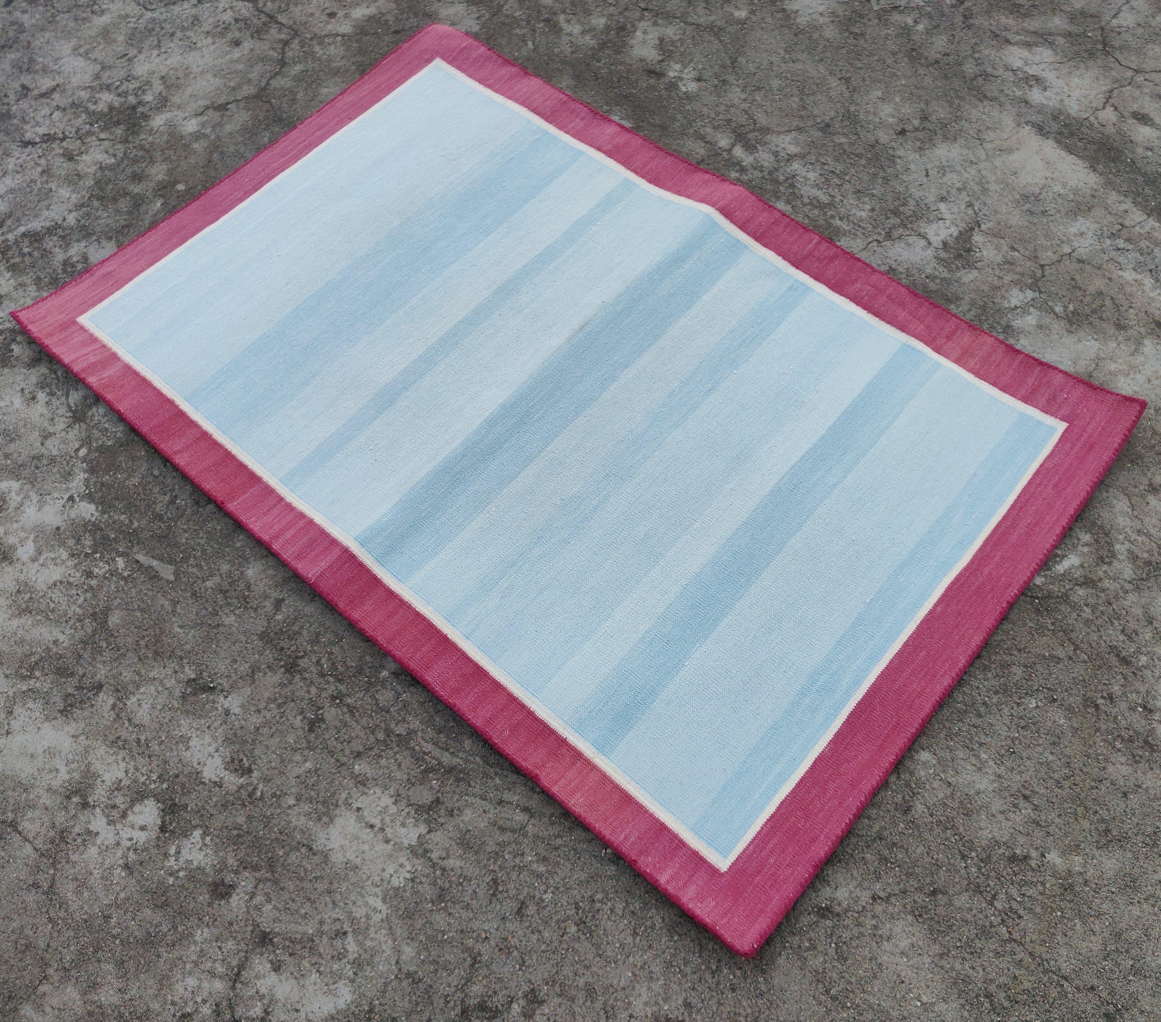 Cotton Vegetable Dyed  Sky Blue, Cream And Raspberry Pink Bordered Indian Dhurrie Rug - 2'x3' (60x90cm) 

These special flat-weave dhurries are hand-woven with 15 ply 100% cotton yarn. Due to the special manufacturing techniques used to create our
