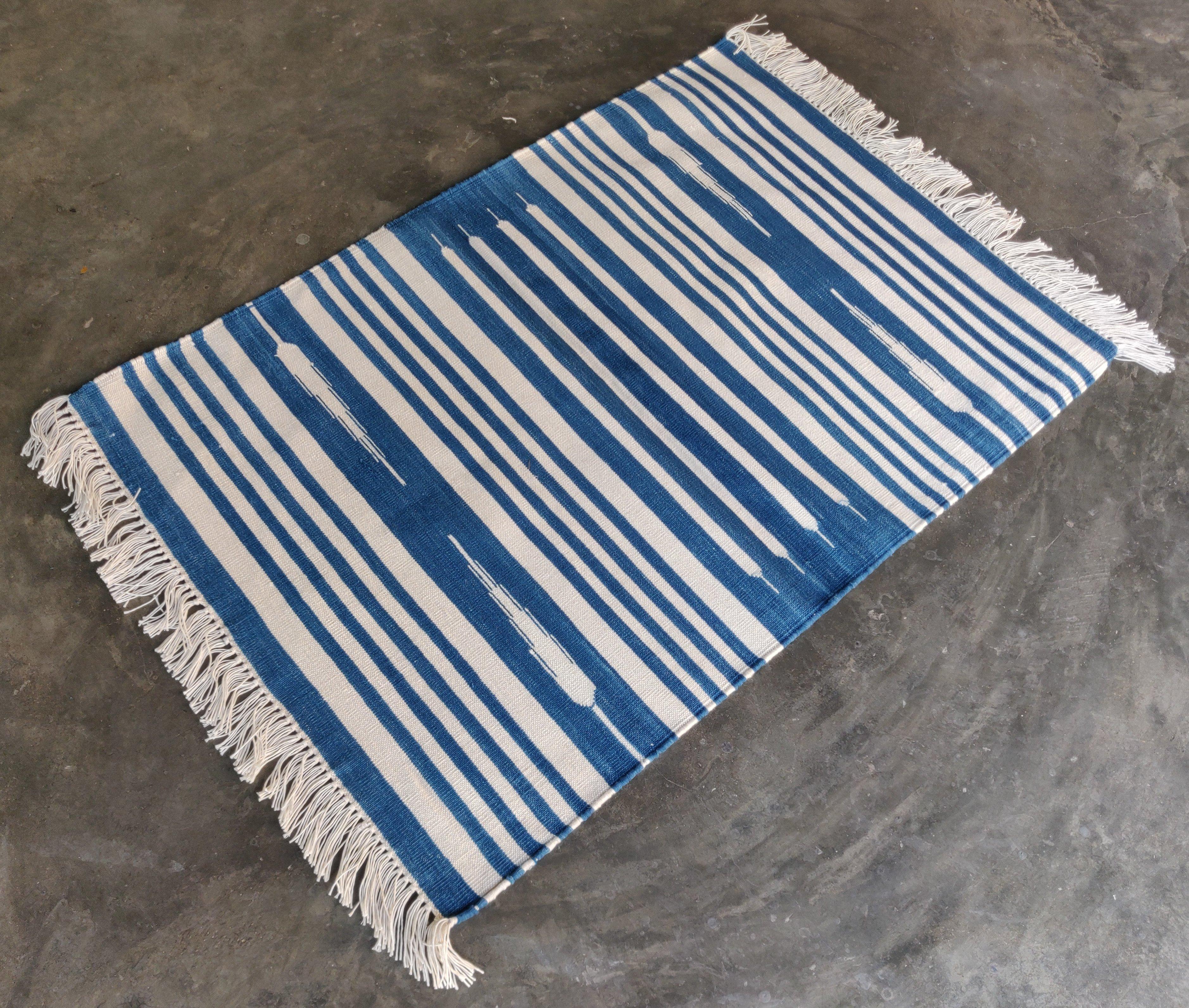 Cotton Vegetable Dyed  Blue And White Striped Indian Dhurrie Rug - 2'x3' (60x90cm) 

These special flat-weave dhurries are hand-woven with 15 ply 100% cotton yarn. Due to the special manufacturing techniques used to create our rugs, the size and