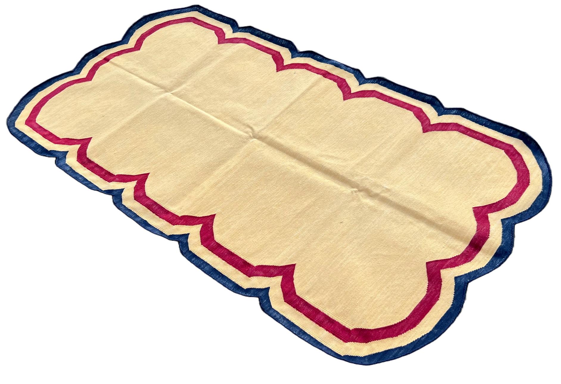 Cotton Vegetable Dyed Cream, Pink And Navy Blue Four Sided Scalloped Rug-3'x5' 
(Scallops runs on all Four Sides)
These special flat-weave dhurries are hand-woven with 15 ply 100% cotton yarn. Due to the special manufacturing techniques used to