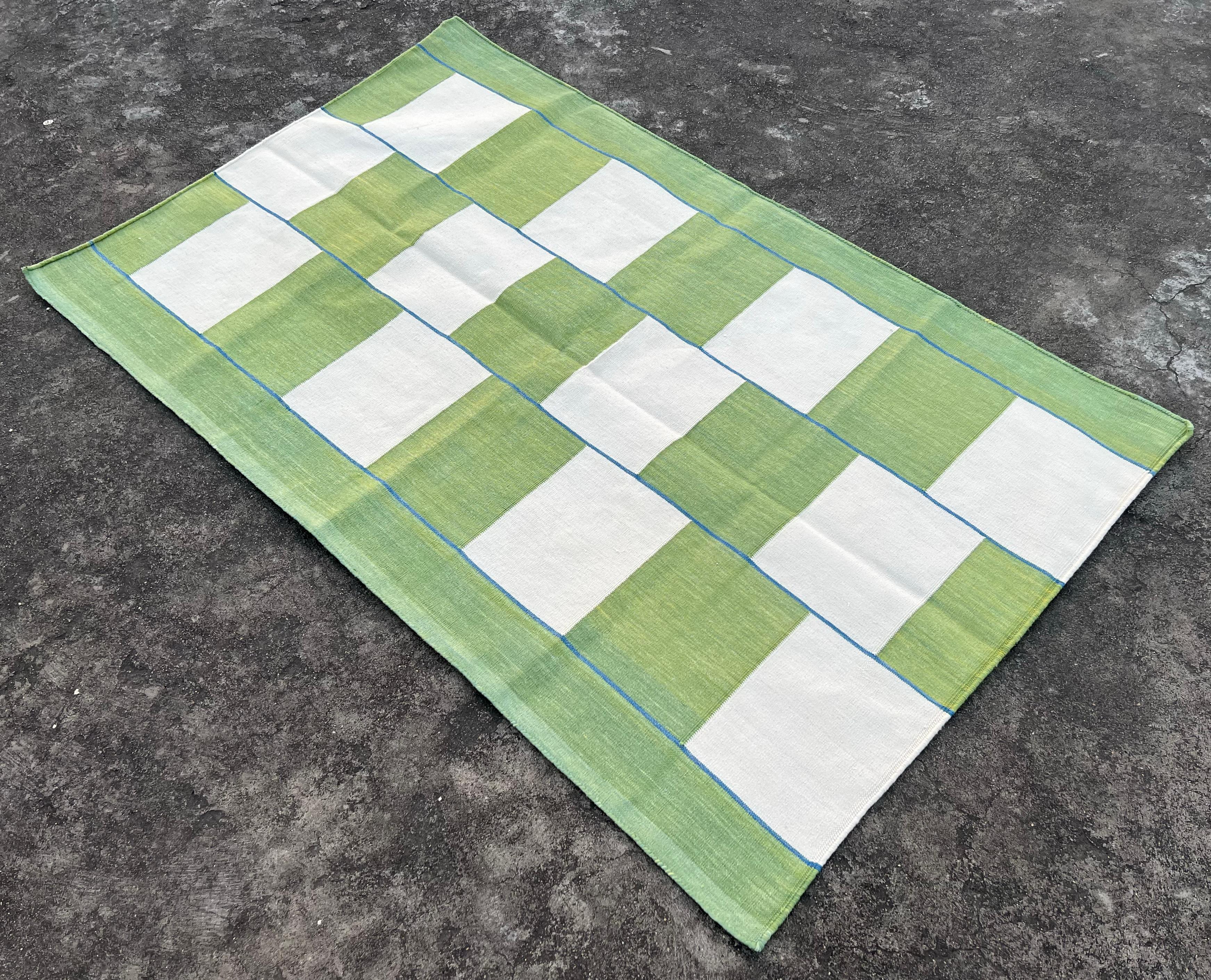 Cotton Vegetable Dyed Moss Green And White Checked Indian Dhurrie Rug-3'x5'

These special flat-weave dhurries are hand-woven with 15 ply 100% cotton yarn. Due to the special manufacturing techniques used to create our rugs, the size and color of