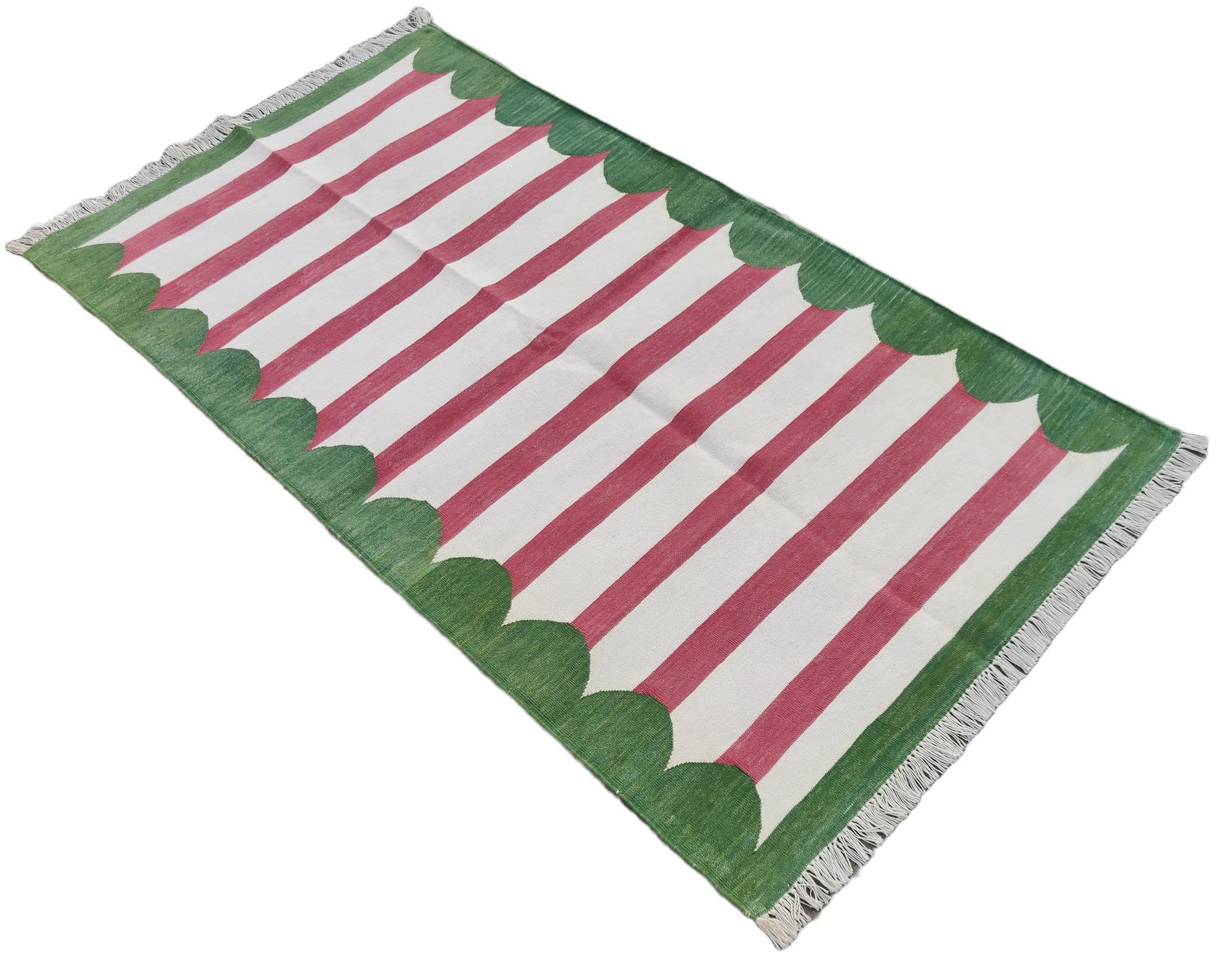 Cotton Vegetable Dyed Pink And Green Scalloped Striped Indian Dhurrie Rug-3'x5' 
These special flat-weave dhurries are hand-woven with 15 ply 100% cotton yarn. Due to the special manufacturing techniques used to create our rugs, the size and color