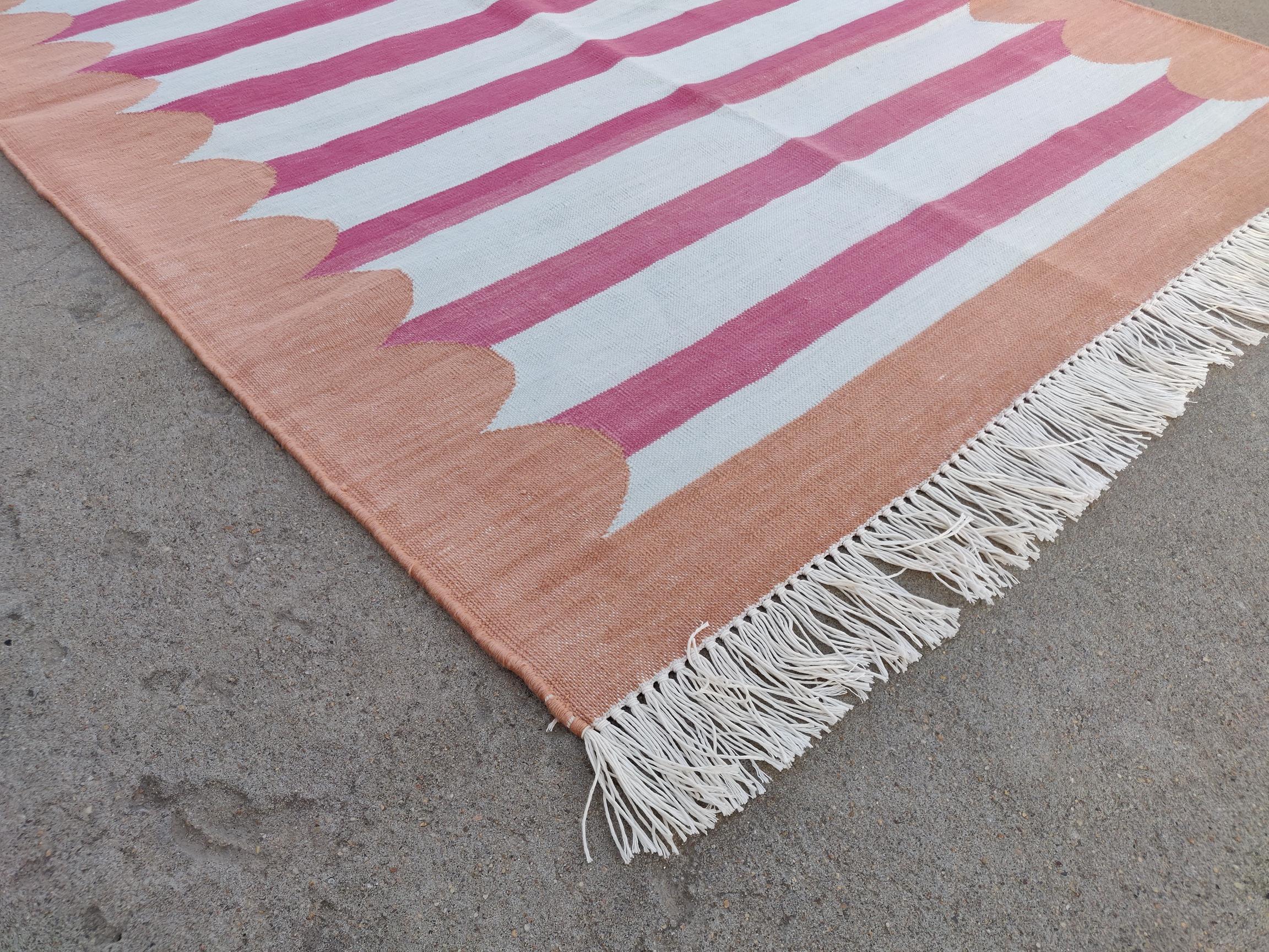 Cotton Vegetable Dyed Pink And Tan Scalloped Striped Indian Dhurrie Rug-3'x5' 
These special flat-weave dhurries are hand-woven with 15 ply 100% cotton yarn. Due to the special manufacturing techniques used to create our rugs, the size and color of