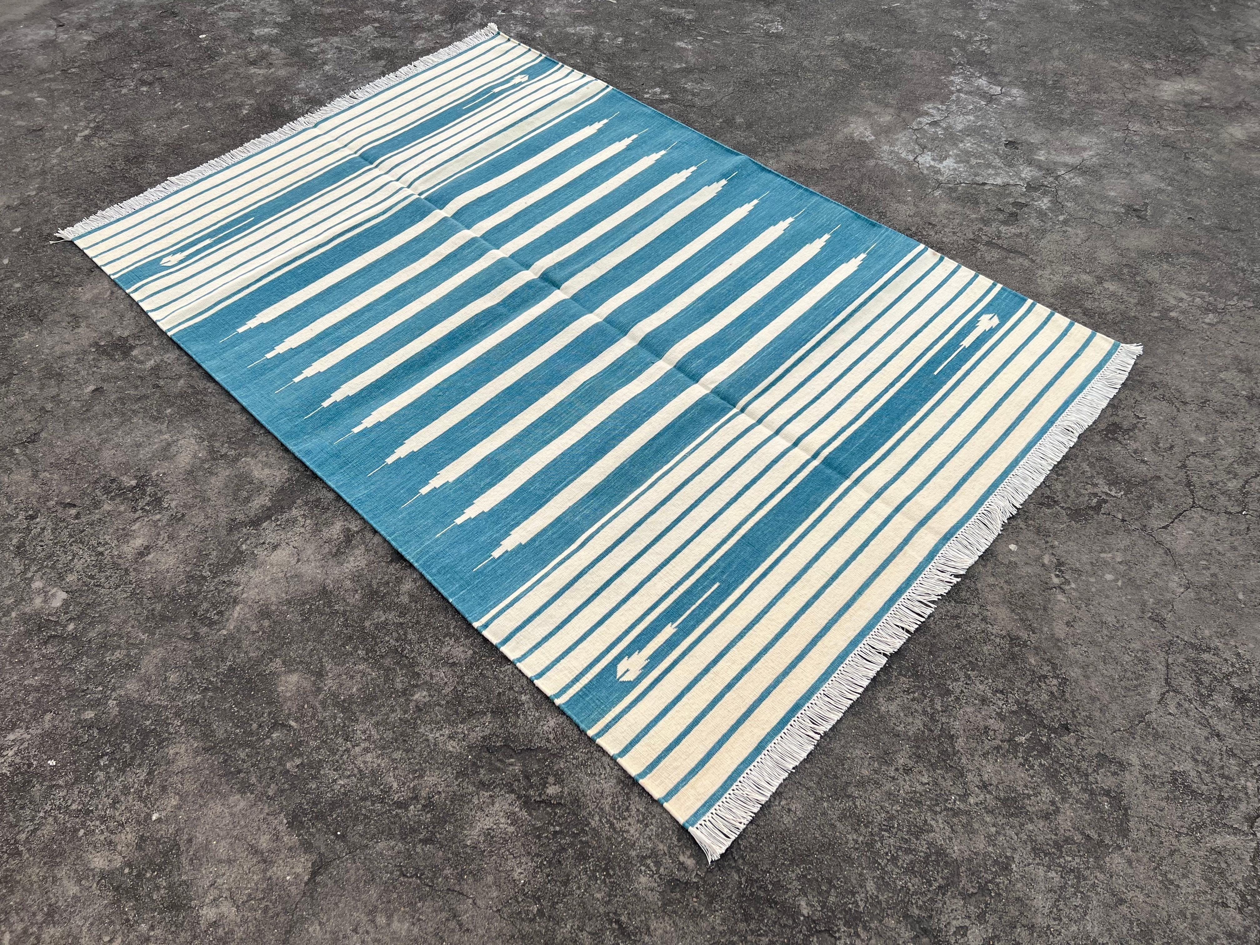 Cotton Vegetable Dyed Cream And Teal Blue Striped Indian Dhurrie Rug-4'x6' 

These special flat-weave dhurries are hand-woven with 15 ply 100% cotton yarn. Due to the special manufacturing techniques used to create our rugs, the size and color of