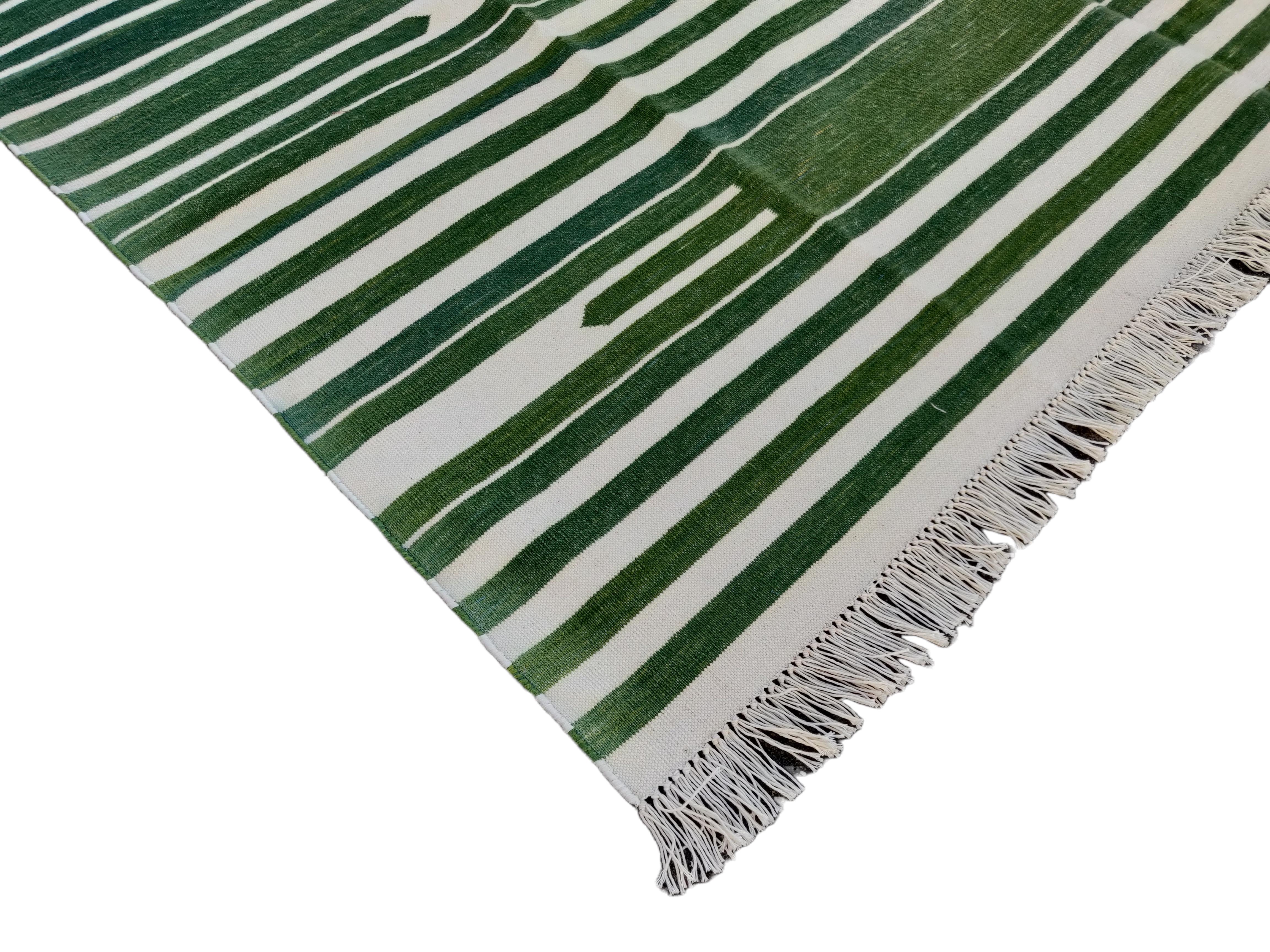 Cotton Vegetable Dyed Green And White Striped Indian Dhurrie Rug-5'x7' (150x210cm) 

These special flat-weave dhurries are hand-woven with 15 ply 100% cotton yarn. Due to the special manufacturing techniques used to create our rugs, the size and