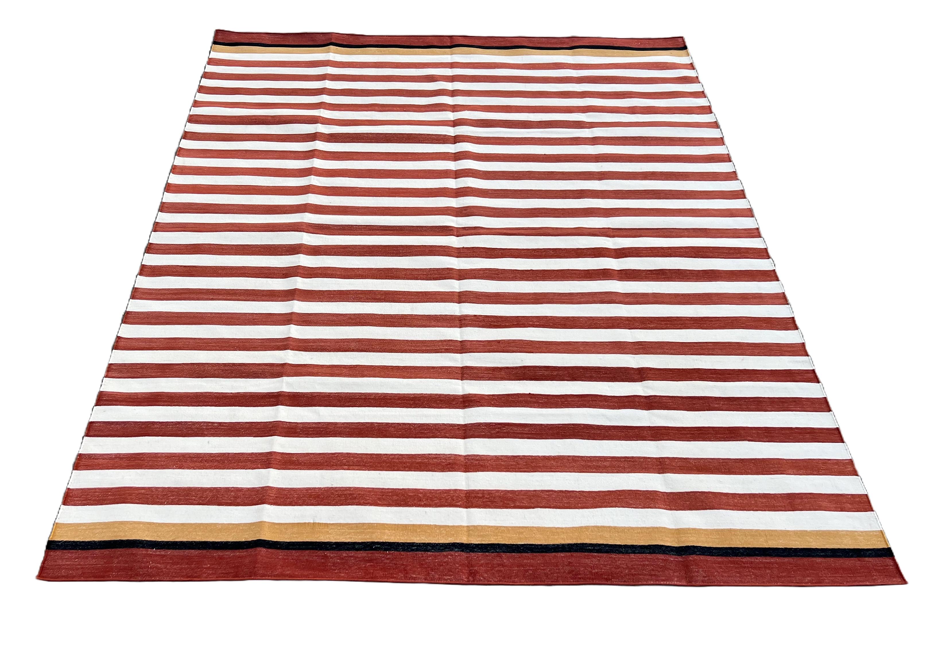 Cotton Vegetable Dyed Terracotta Red, Cream, Yellow And Black Striped Indian Dhurrie Rug-5'x7' (150x210cm) 

These special flat-weave dhurries are hand-woven with 15 ply 100% cotton yarn. Due to the special manufacturing techniques used to create