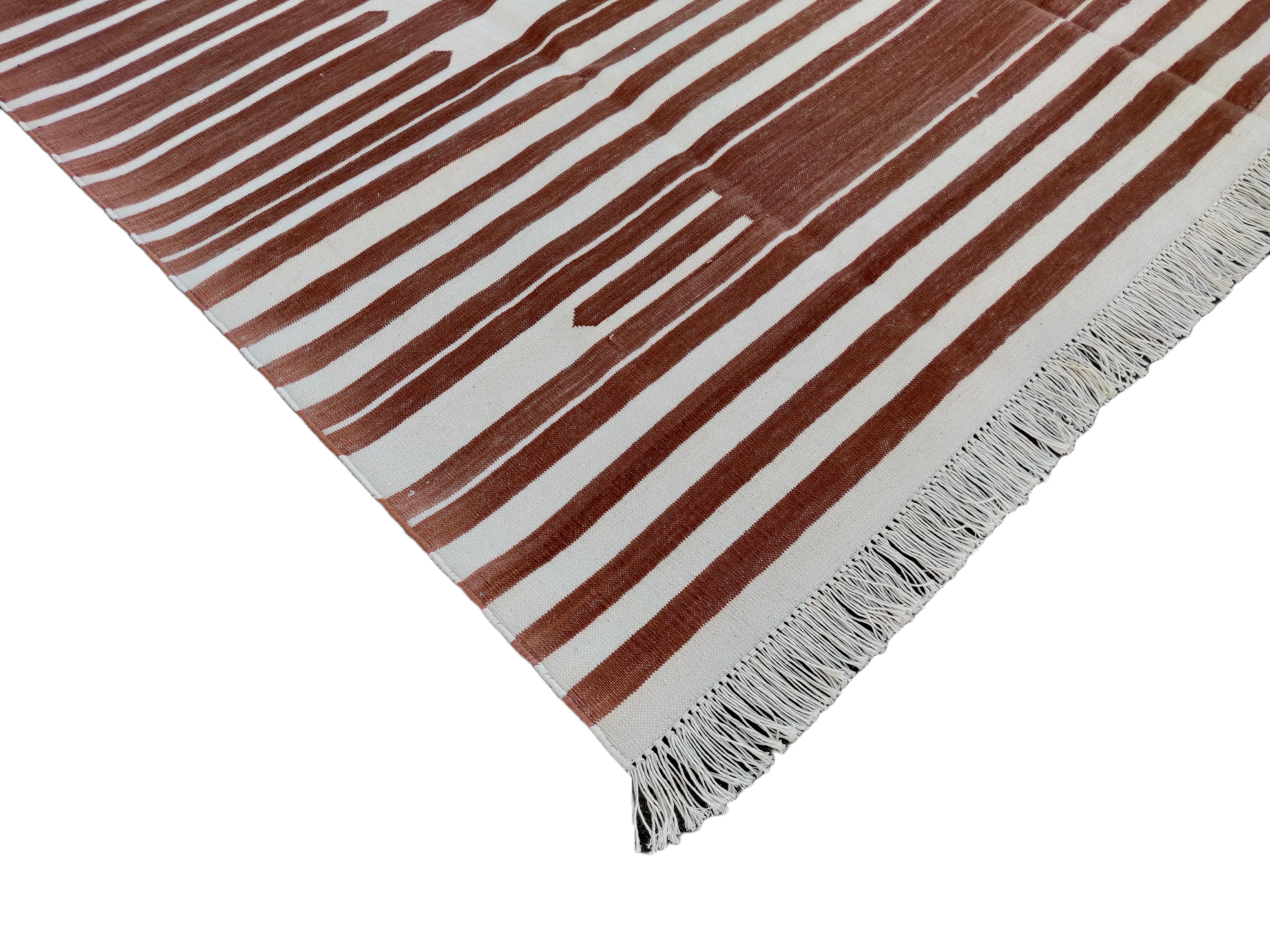 Cotton Vegetable Dyed Tan And White Striped Indian Dhurrie Rug-5'x7' (150x210cm) 

These special flat-weave dhurries are hand-woven with 15 ply 100% cotton yarn. Due to the special manufacturing techniques used to create our rugs, the size and color