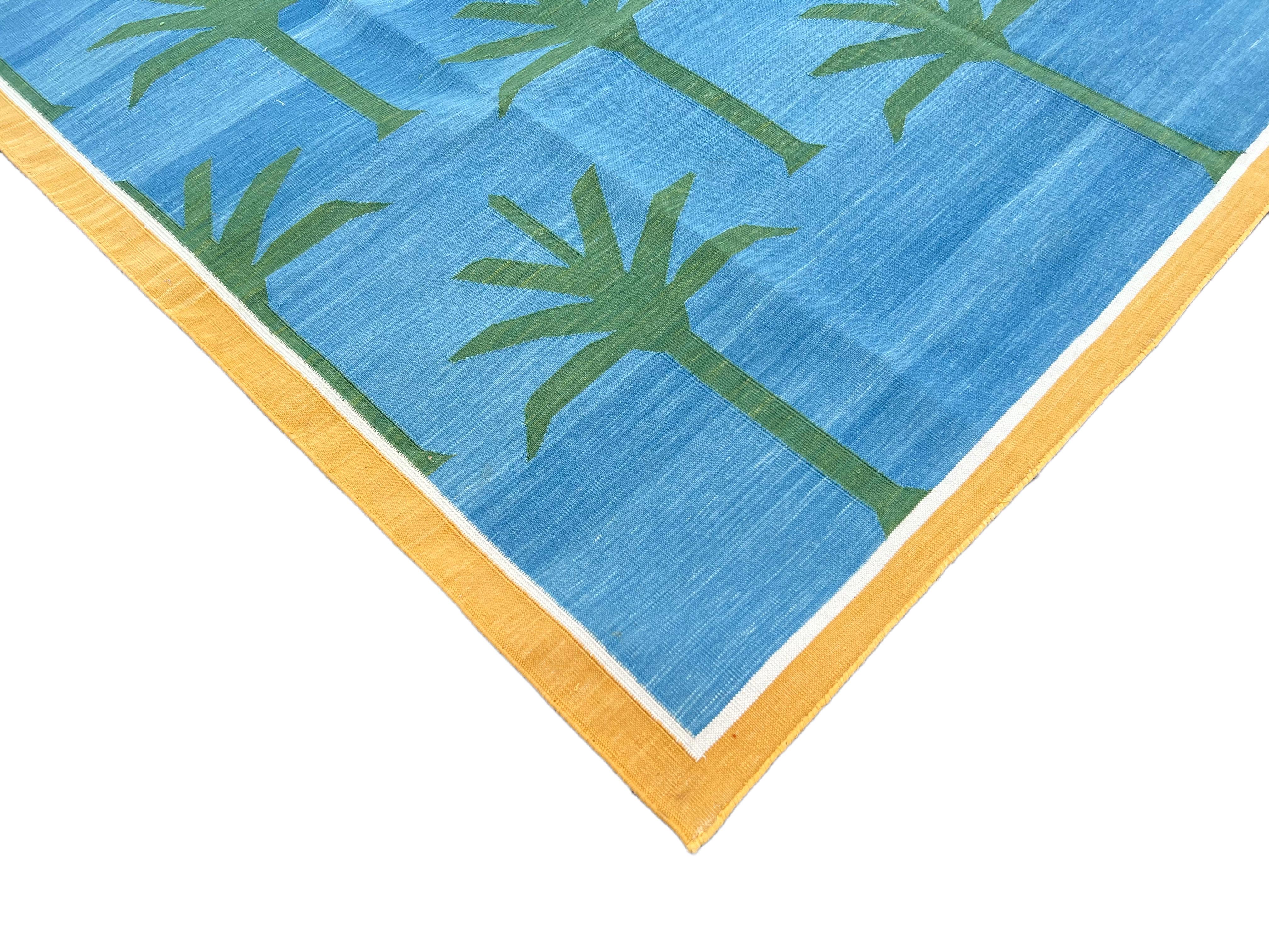 Cotton Vegetable Dyed Sky Blue, Forest Green Palm And Yellow Border Tree Indian Dhurrie Rug-5'x8' 
These special flat-weave dhurries are hand-woven with 15 ply 100% cotton yarn. Due to the special manufacturing techniques used to create our rugs,