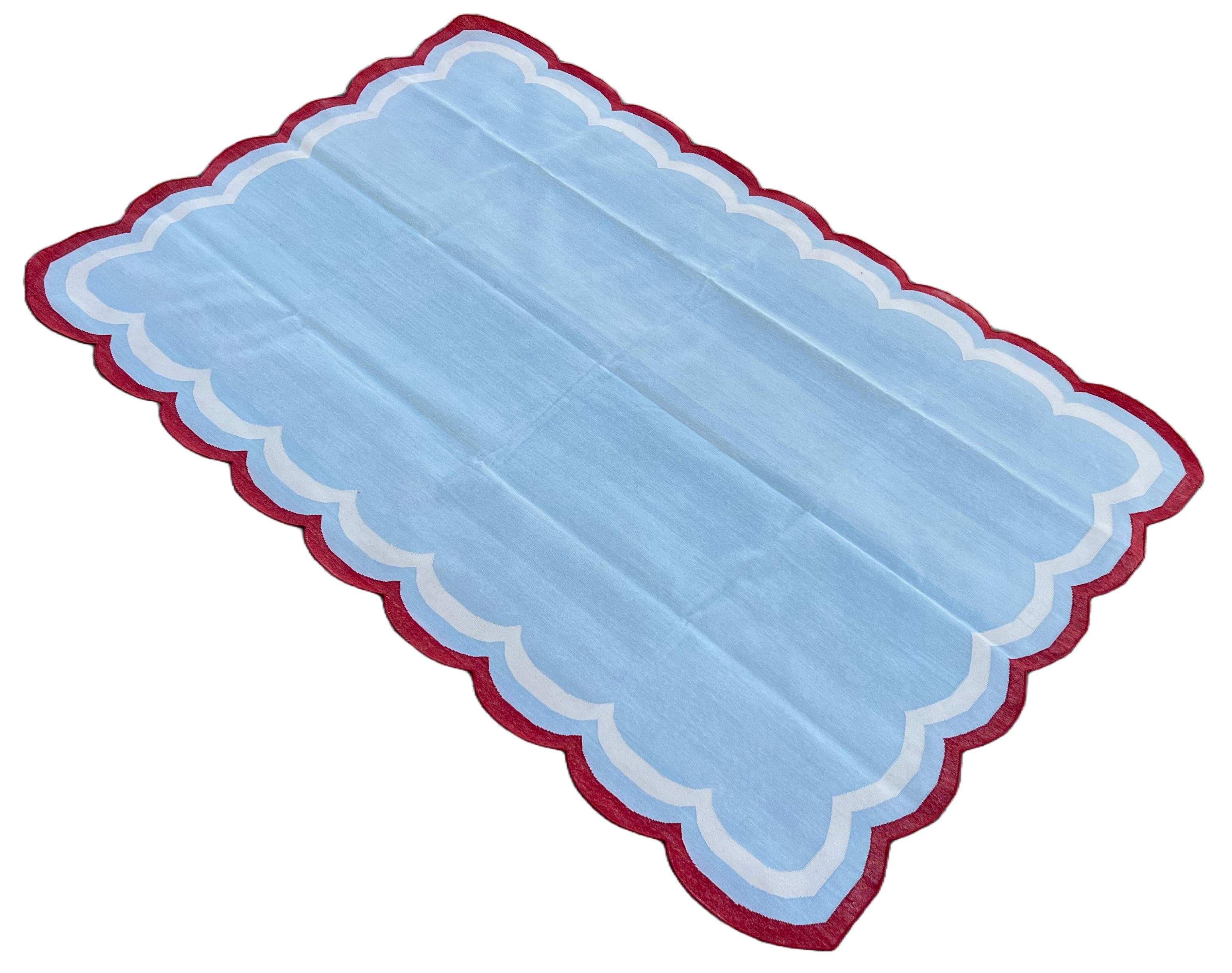 Cotton Vegetable Dyed Sky Blue, Cream And Tomato Red Four Sided Scalloped Rug-6'x9' (Scallops runs on all Four Sides)

These special flat-weave dhurries are hand-woven with 15 ply 100% cotton yarn. Due to the special manufacturing techniques used to