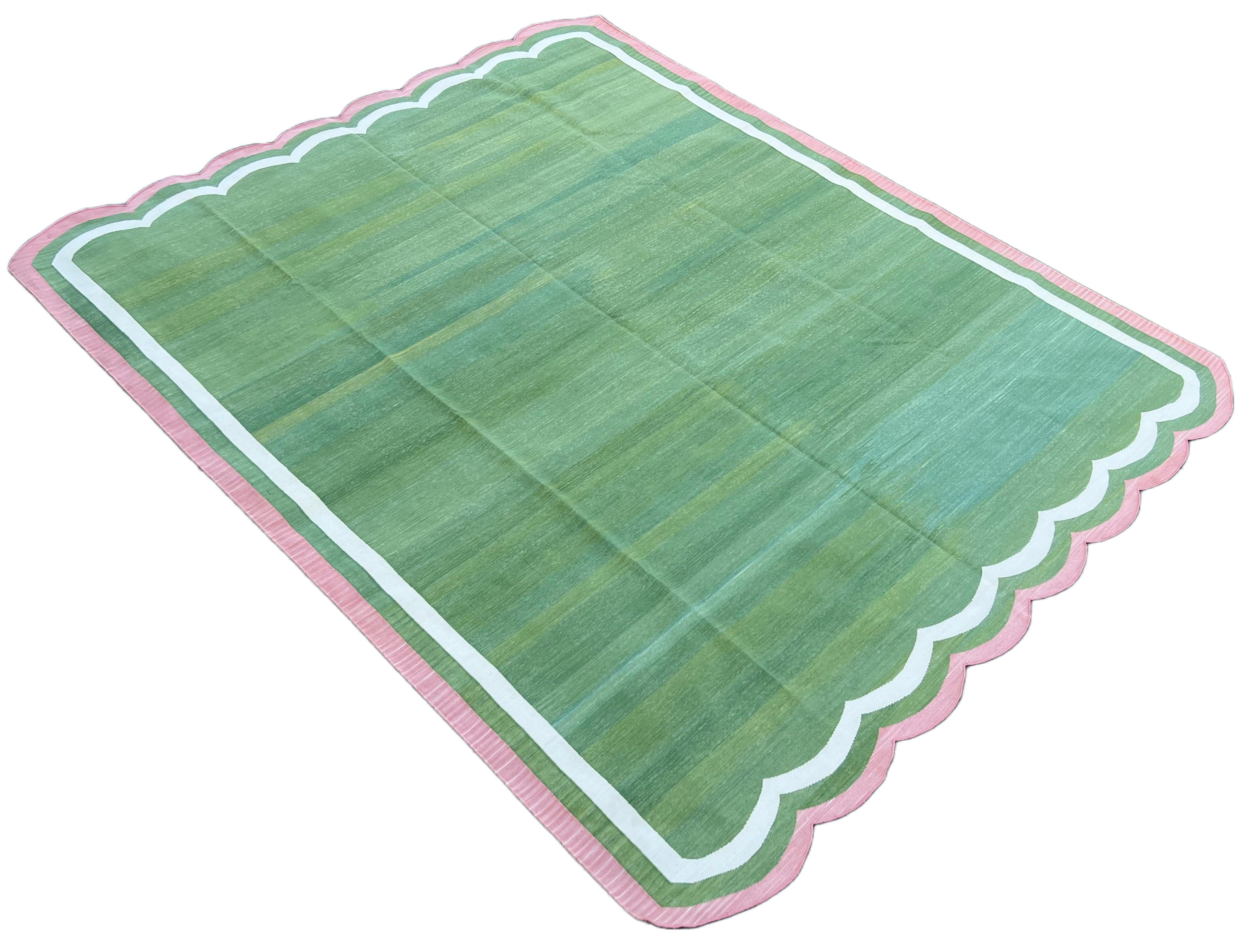Cotton Vegetable Dyed Moss Green and Pink 2 Sided Indian Scalloped Rug - 8'x10'
These special flat-weave dhurries are hand-woven with 15 ply 100% cotton yarn. Due to the special manufacturing techniques used to create our rugs, the size and color of