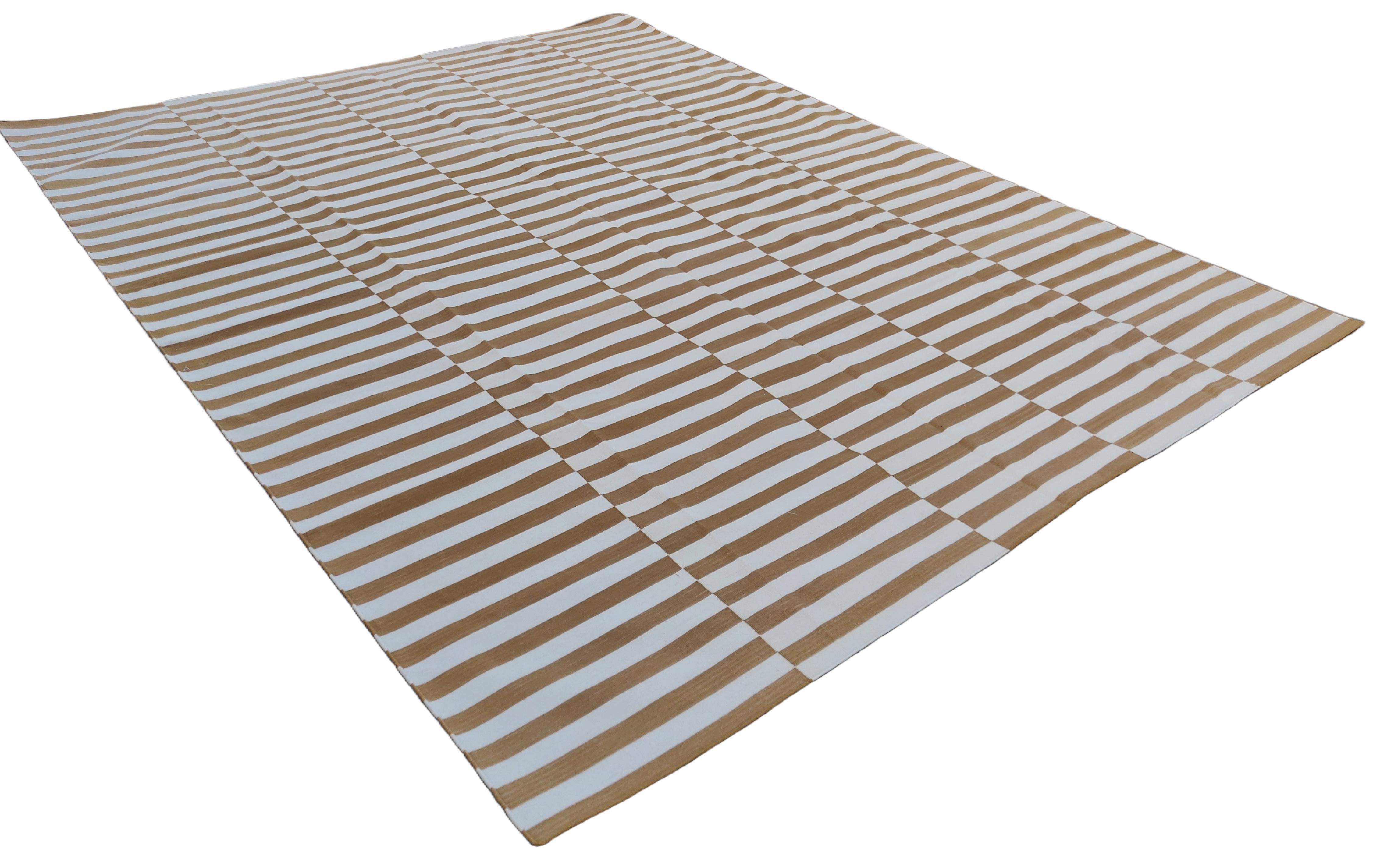 Cotton Vegetable Dyed Tan And White Up Down Striped Indian Dhurrie Rug-9'x12' 
These special flat-weave dhurries are hand-woven with 15 ply 100% cotton yarn. Due to the special manufacturing techniques used to create our rugs, the size and color of