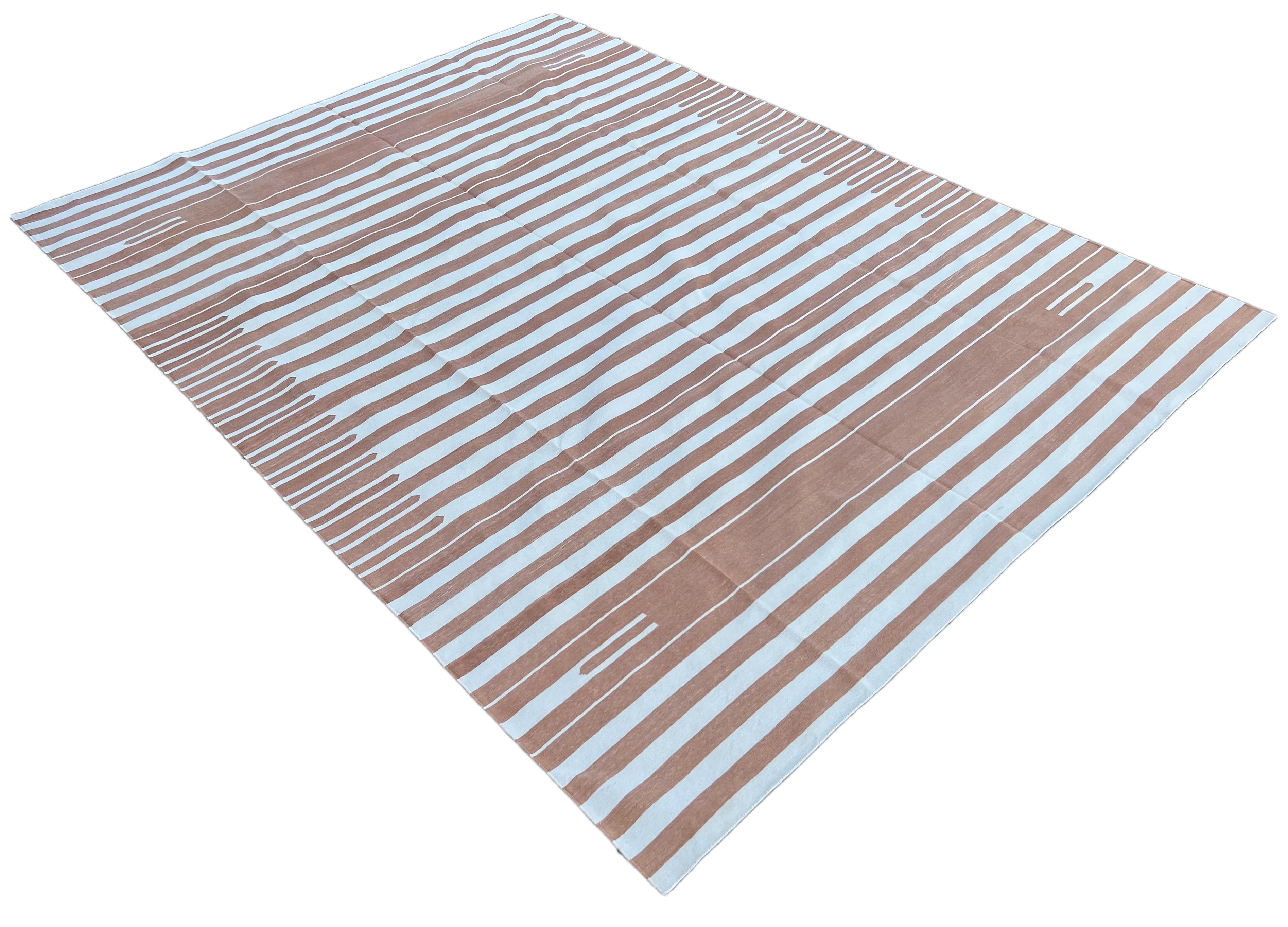 Cotton Vegetable Dyed Tan And White Up Down Striped Indian Dhurrie Rug-9'x12' 
These special flat-weave dhurries are hand-woven with 15 ply 100% cotton yarn. Due to the special manufacturing techniques used to create our rugs, the size and color of