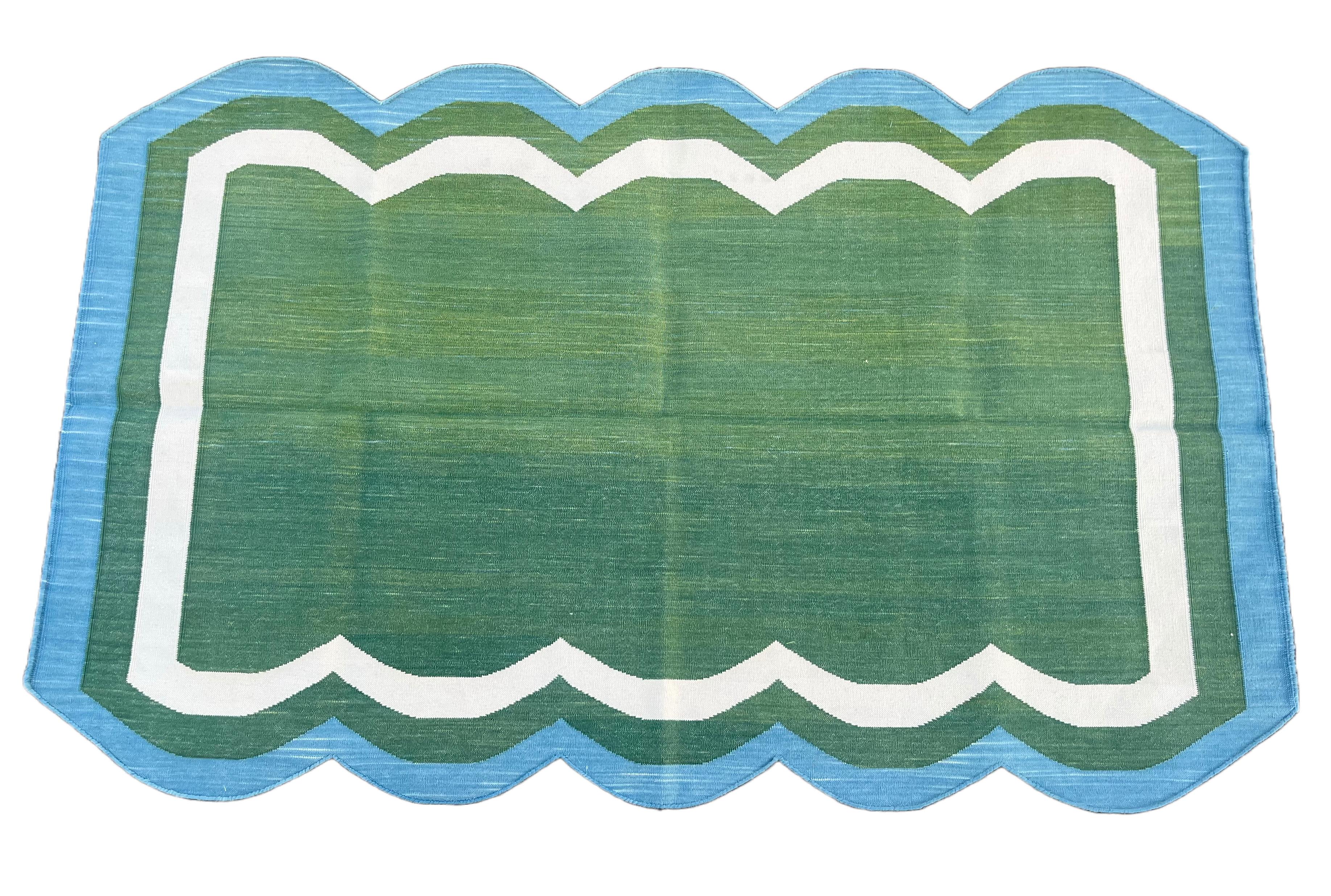 Cotton Vegetable Dyed Reversible Forest Green And Blue Two Sided Scalloped Indian Rug - 3'x5'
(Scallops runs on 5' sides)
These special flat-weave dhurries are hand-woven with 15 ply 100% cotton yarn. Due to the special manufacturing techniques used