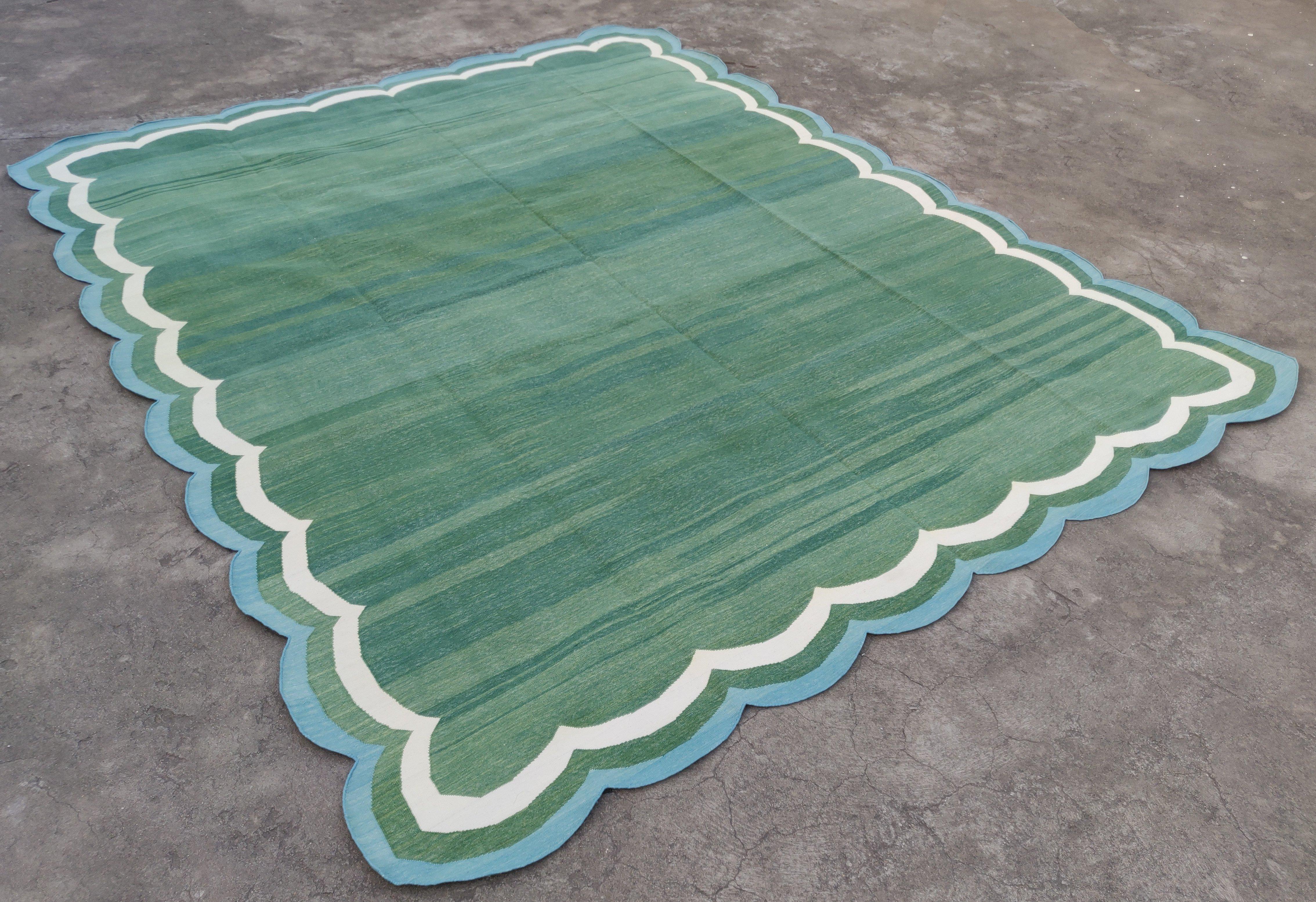 Cotton Vegetable Dyed Forest Green, Cream And Blue Scalloped Rug-8'x10'
(Scallops runs all four sides)
These special flat-weave dhurries are hand-woven with 15 ply 100% cotton yarn. Due to the special manufacturing techniques used to create our