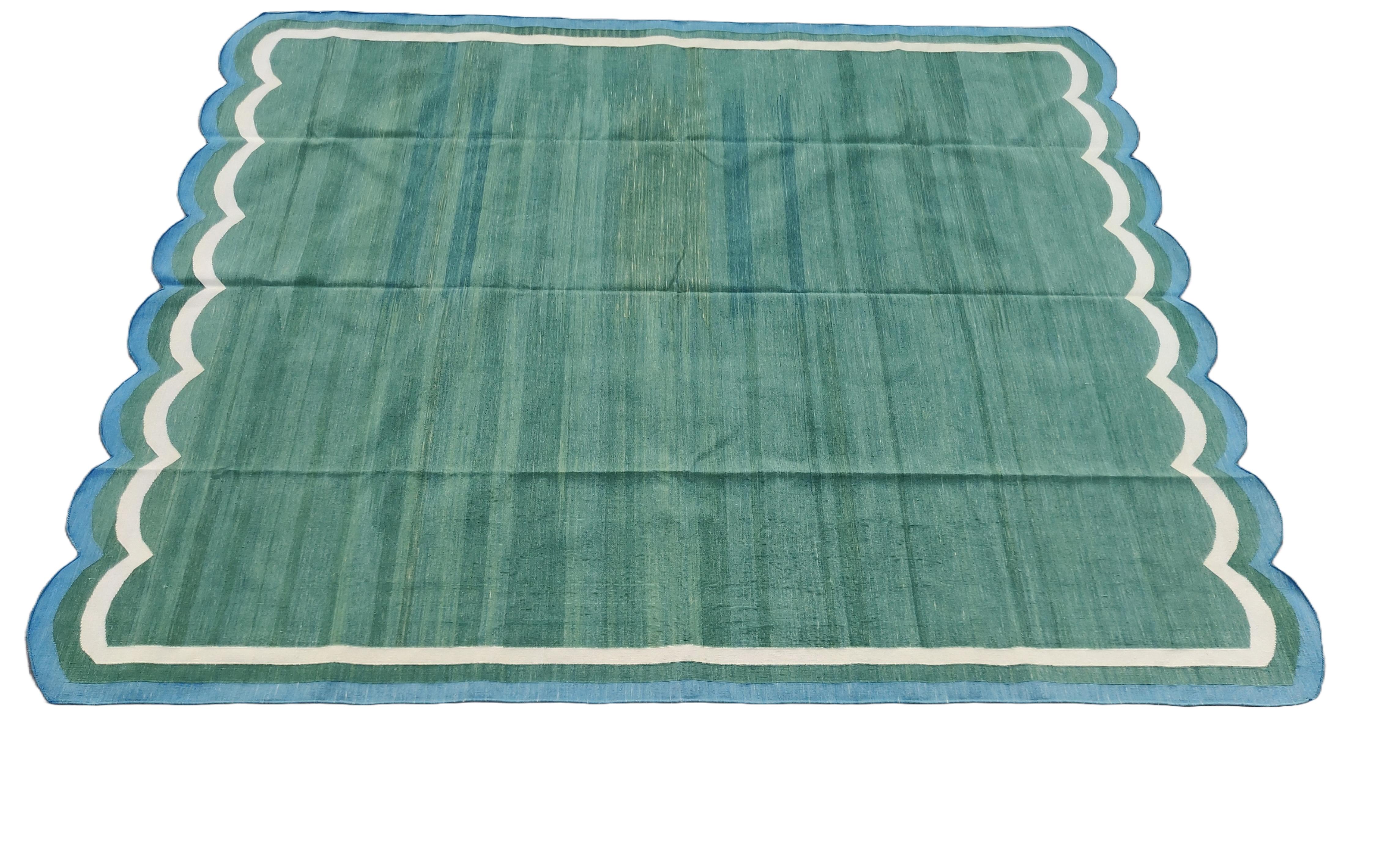 Cotton Vegetable Dyed Forest Green And Blue Scalloped Rug-8'x10'
These special flat-weave dhurries are hand-woven with 15 ply 100% cotton yarn. Due to the special manufacturing techniques used to create our rugs, the size and color of each piece may