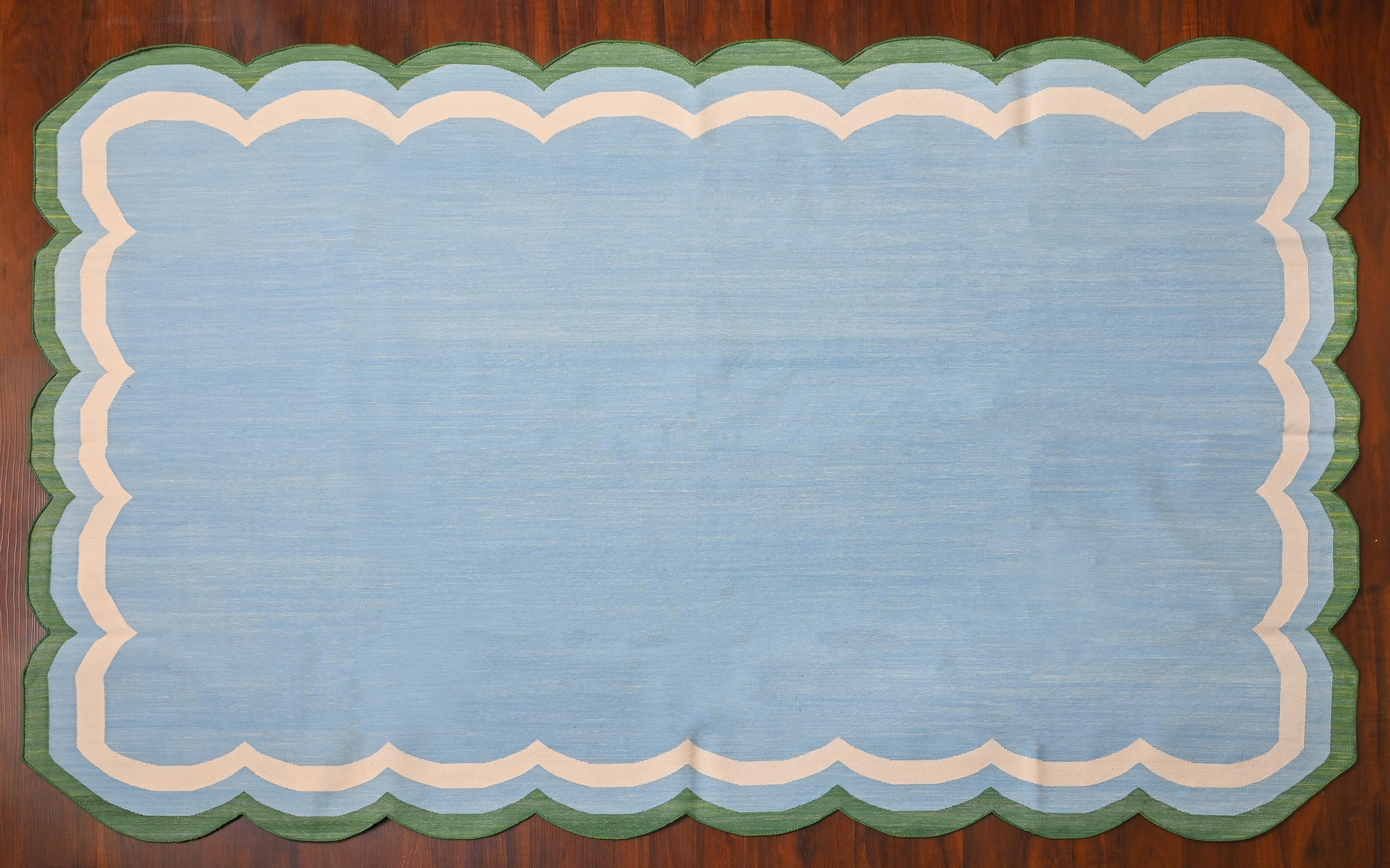 Cotton Vegetable Dyed Reversible Sky Blue And White Four Sided Scalloped Indian Rug - 5'x8'
These special flat-weave dhurries are hand-woven with 15 ply 100% cotton yarn. Due to the special manufacturing techniques used to create our rugs, the size