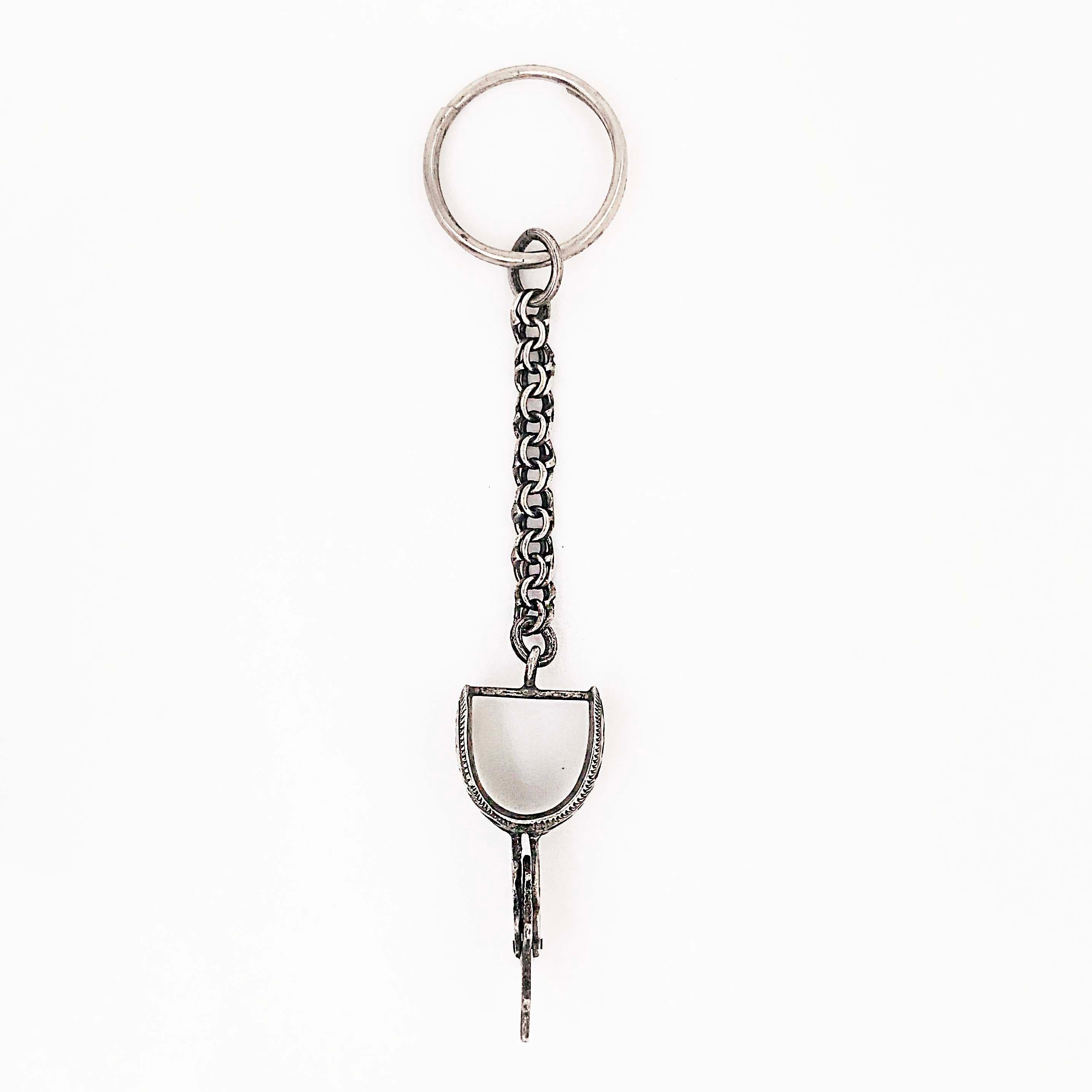 The sterling cowboy keychain is a hand fabricated estate piece. The keychain has a cowboy spur that has been handmade with intricate hand engraving detail work! The keychain is sterling silver with an oxidized finish that gives the piece a wester