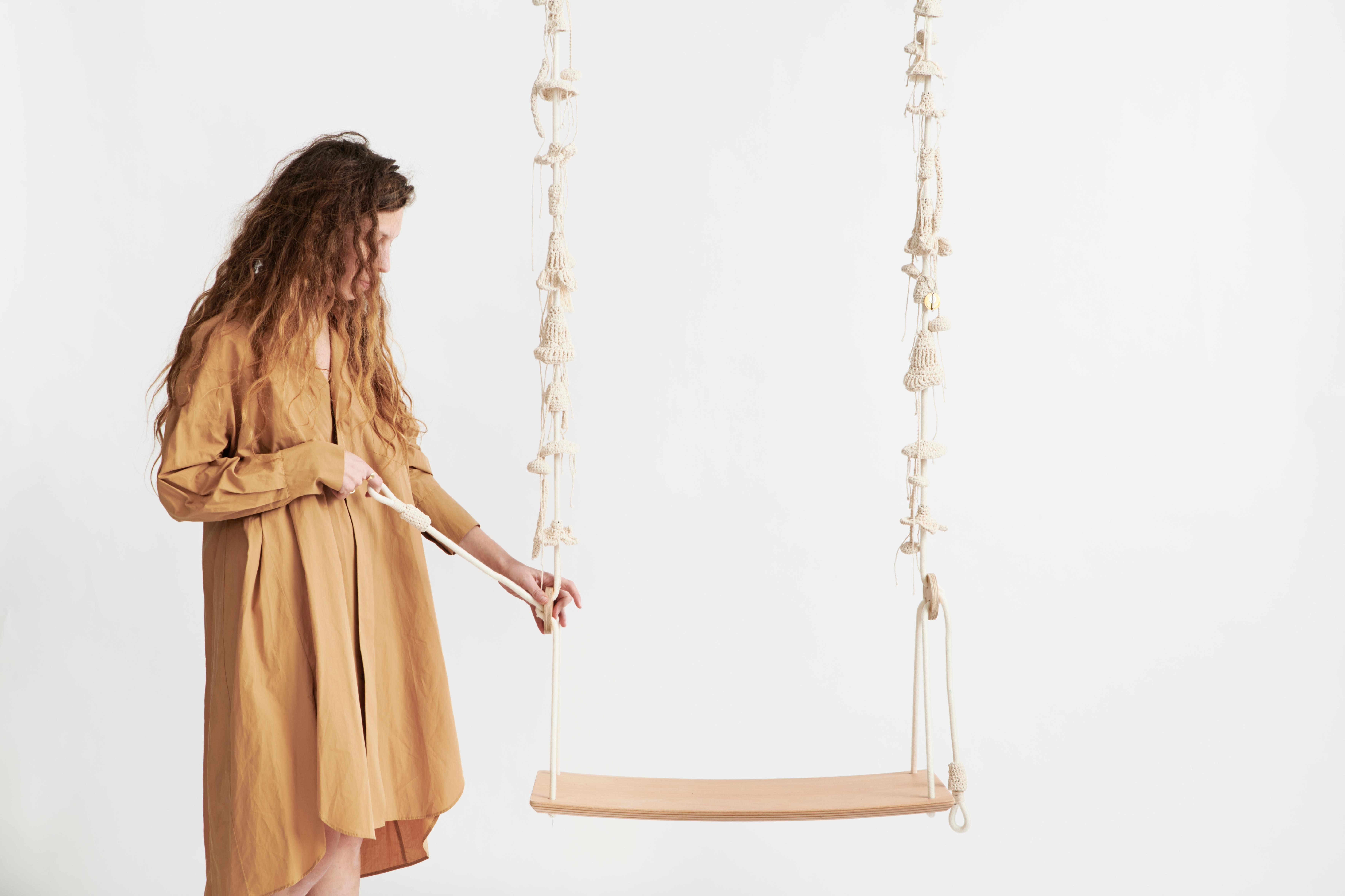 The dune swing, inspired by climbing plants in dry climates, takes the user to a wild, natural, fantastic place. The swing showcases much of our special knitted hand work. It contains 93 hand knitted elements changing in shape, size and color. They