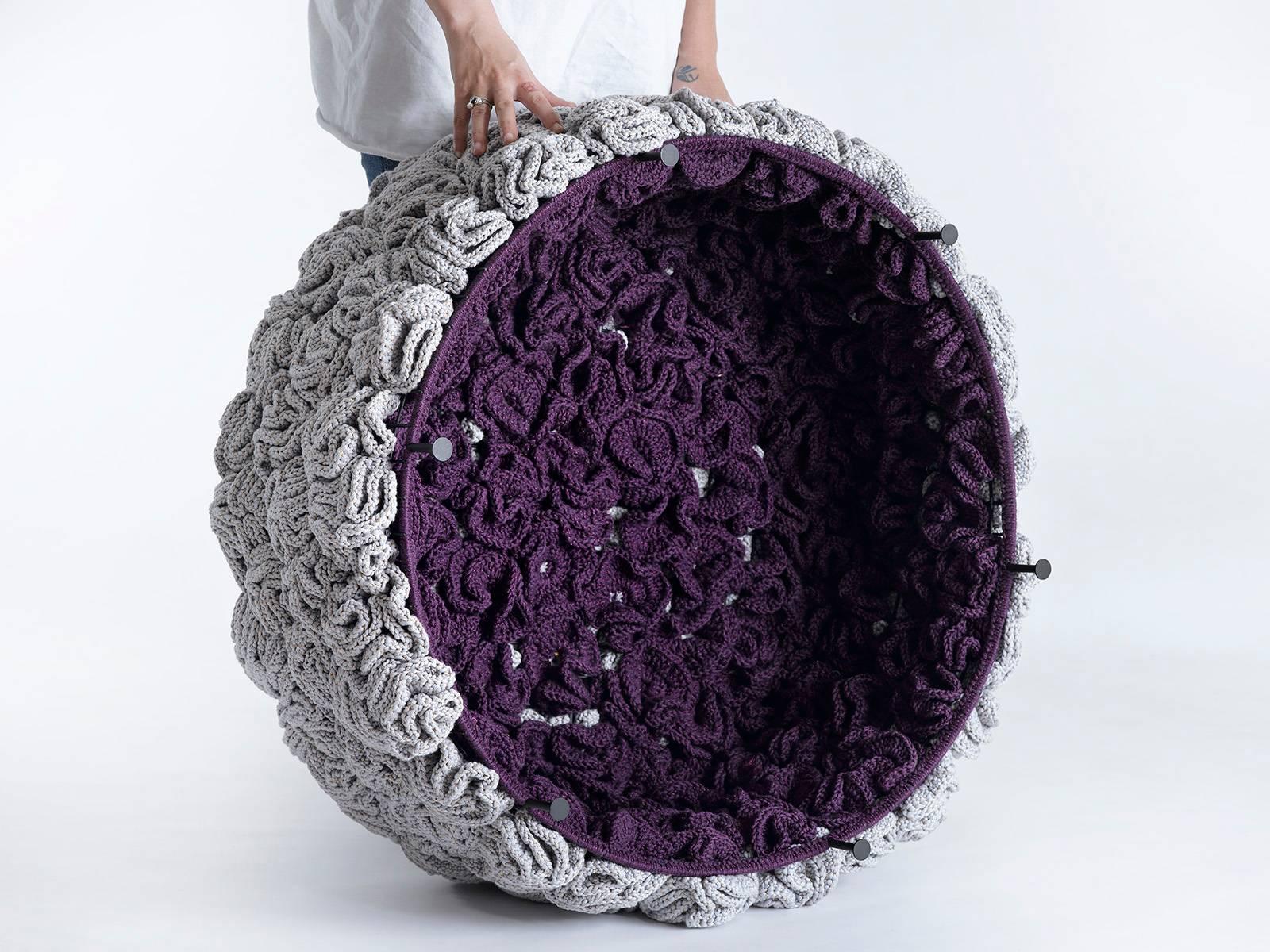 The iota pouf challenges the classic upholstery technique and offers a new concept. The luscious, soft look and feel conceals a metal construction which gives it stiffness. The textile cover of the pouf is composed of dozens of hand knit flower-