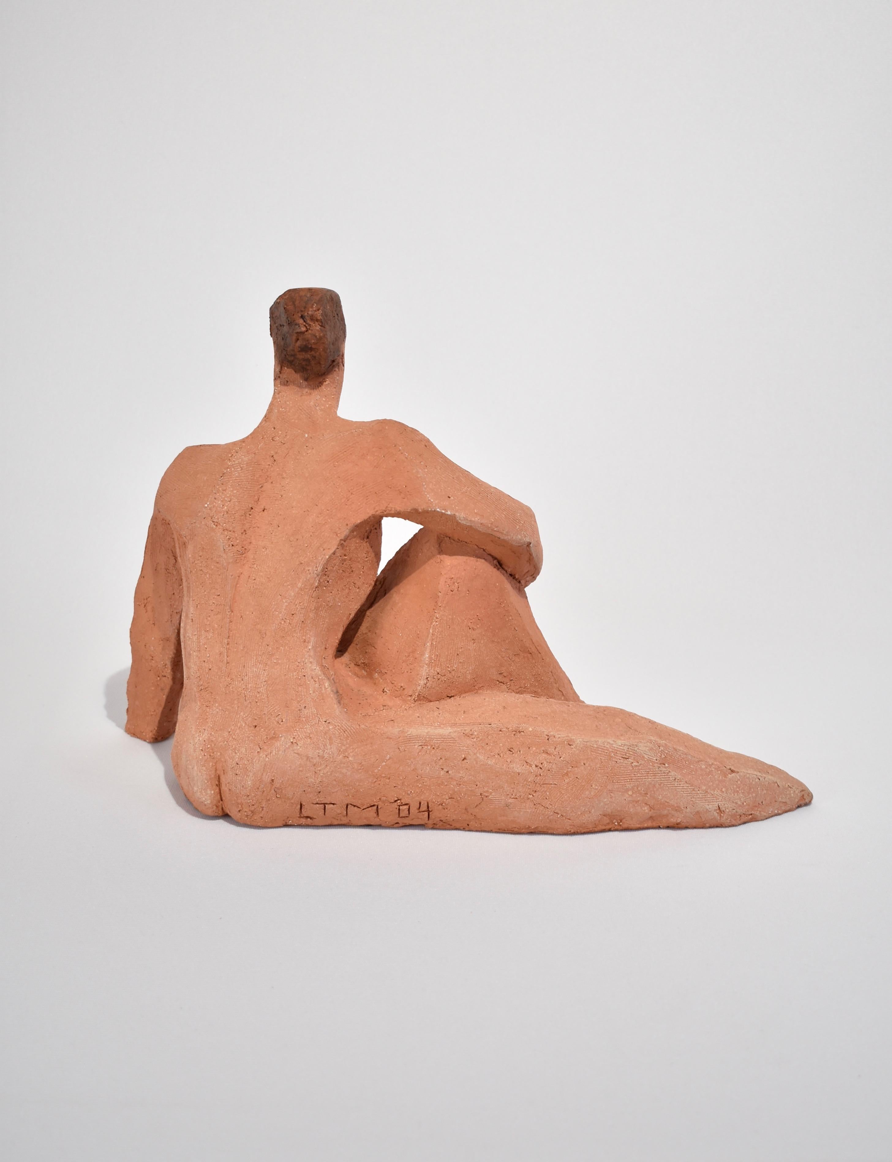 Cubist female figure sculpture in terracotta. Signed LTM '04.