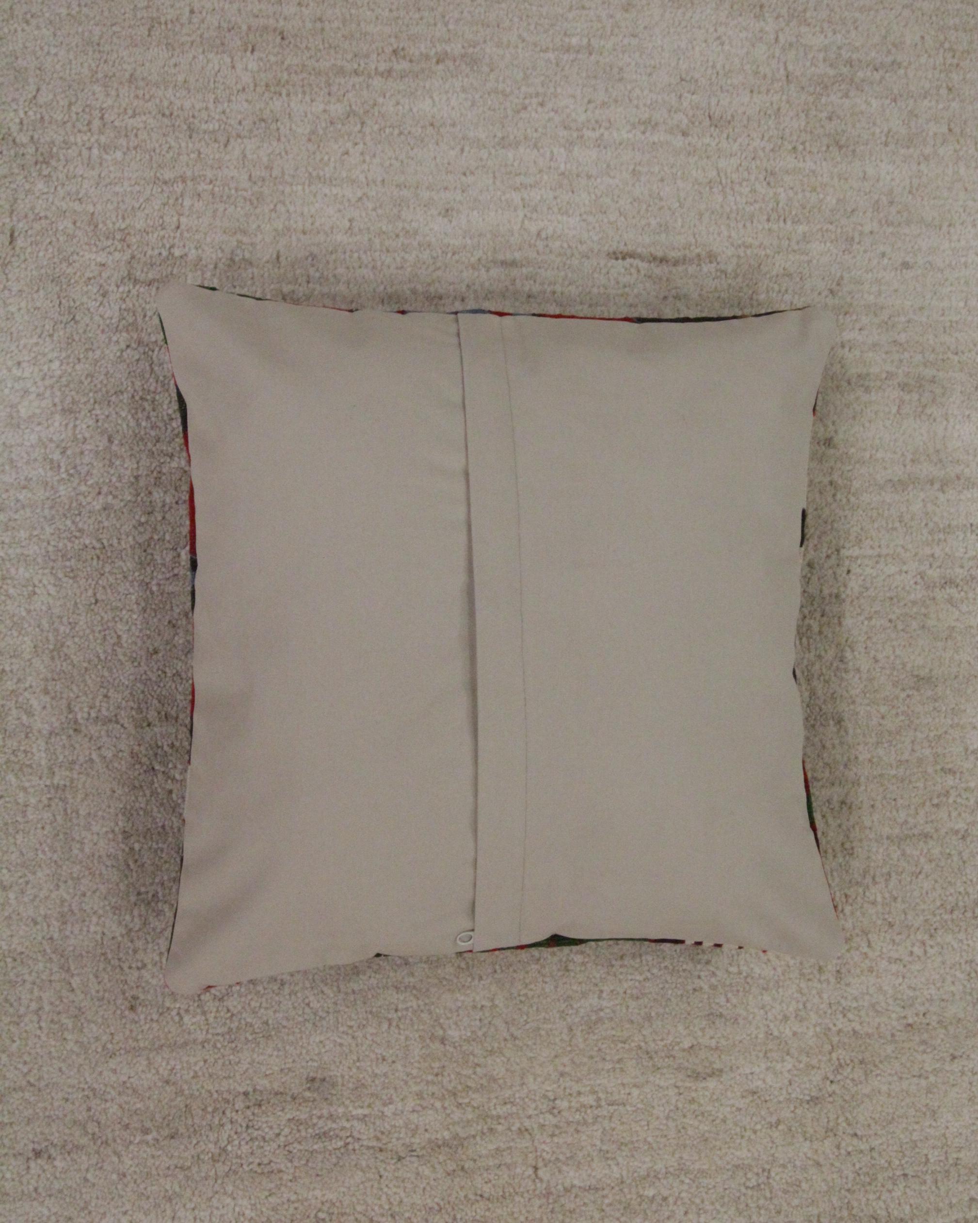 This unique geometric cushion cover is a modern handwoven Turkish Kilim cushion cover. The design features traditional geometric designs woven in blue, red, cream and green. The traditional design and bold primary colours featured in this scatter