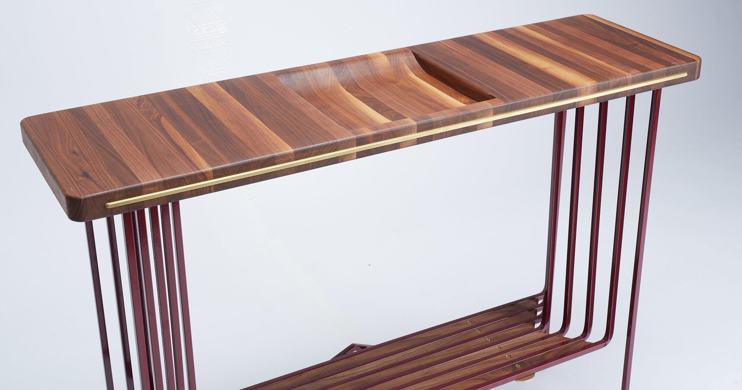 This table has detail from top to bottom. The edge grain American walnut allows us to hand shape a bowl into the top for your every day essentials and the bottom shelf is a perfect place for a plant or your favorite decoration. Brass screws and