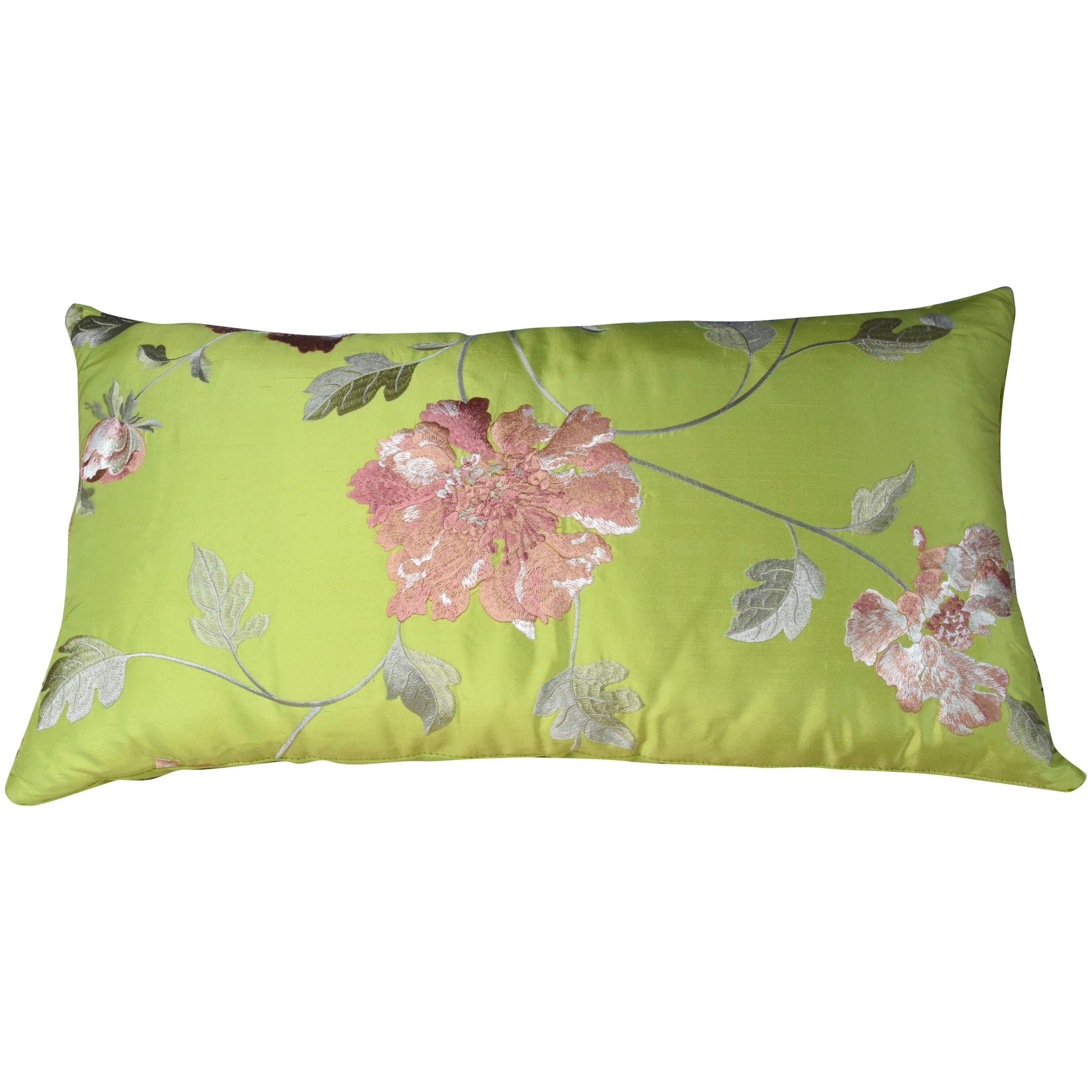 A rectangular lime-green handmade cushion covered in designer silk. The light pink floral embroidered pattern will bring life to the rest of your furniture. The back-side is in velvet.
Our pillows are handmade using limited edition fabrics from