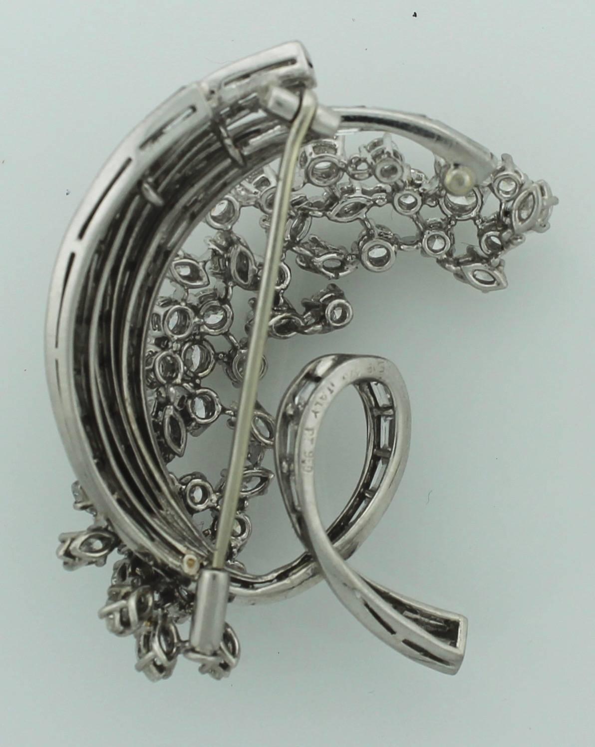 Welcome to the fifties! A floral handmade platinum and diamond brooch. Weighing in with a total diamond weight of 8.85 carats of round brilliant cuts and baggettes approximately.  All diamonds are fine quality (GH VVS-VS)