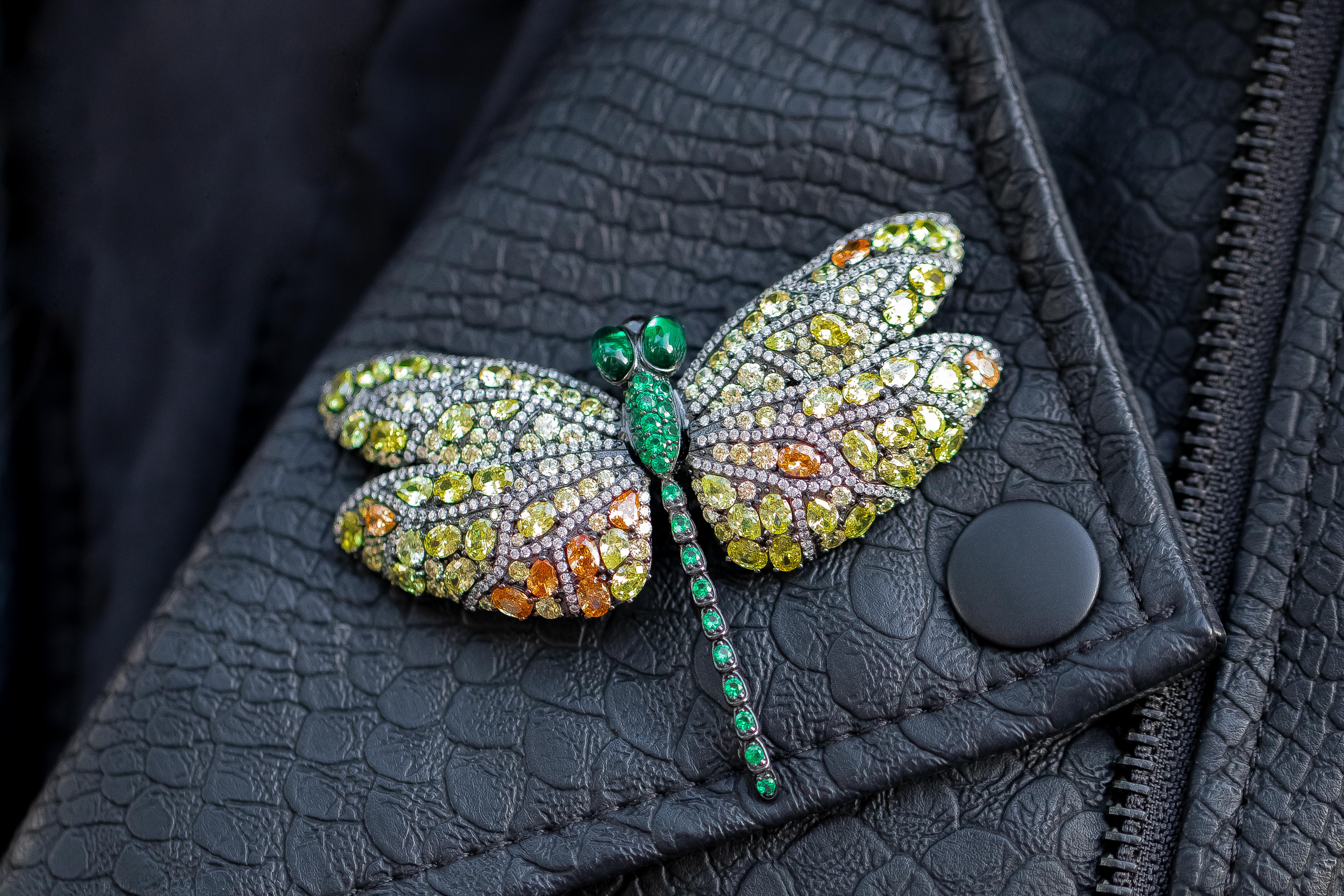 With its bright tones of green, orange, yellow and white this dragonfly pin adds a touch of fun to any outfit. Each piece is carefully fashioned from sterling silver and multicolored cubic zirconia stones. Perfect Valentine's day, Birthday or