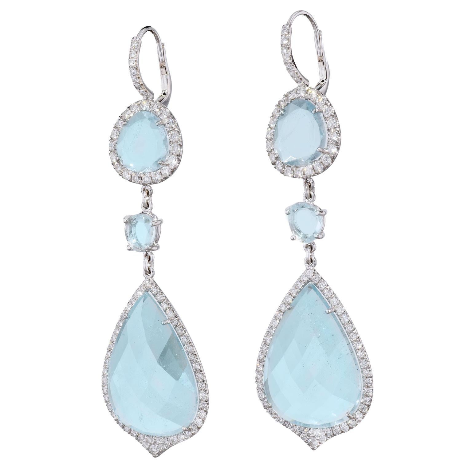 Handmade Drop Blue Topaz Slice Earrings 18kt Gold

Handmade Blue Topaz Slice Earrings. The topaz's have a total weight of 37.42 carats and are surrounded by 1.81 carat round brilliant cut diamond pave set G/H I1. 