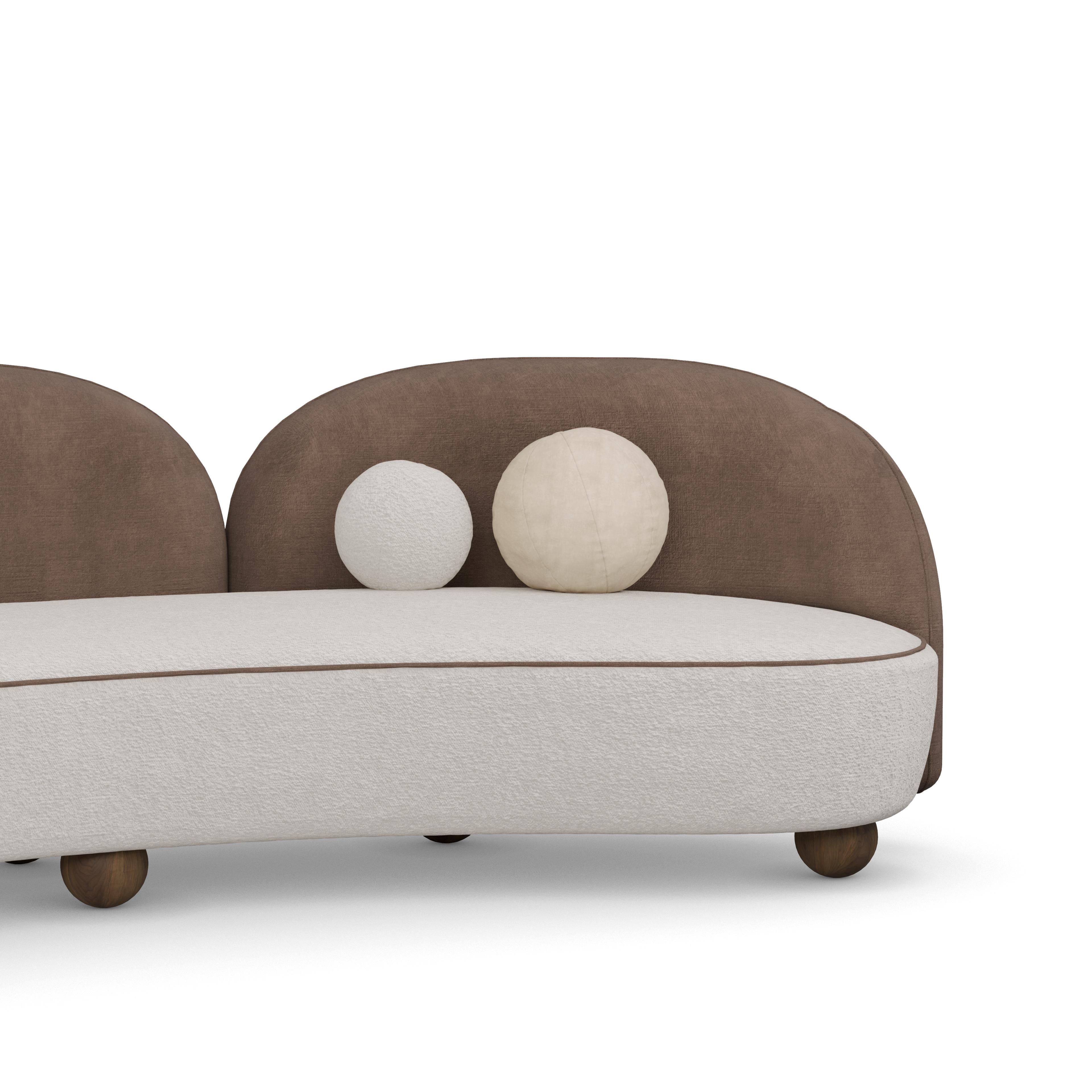 Ellora sofa redefines modern luxury with its elegant curves and striking asymmetrical design. Upholstered in a soft, dual-tone fabric, this sofa blends earthy sophistication with contemporary flair. Its sculptural backrests flow gracefully, creating