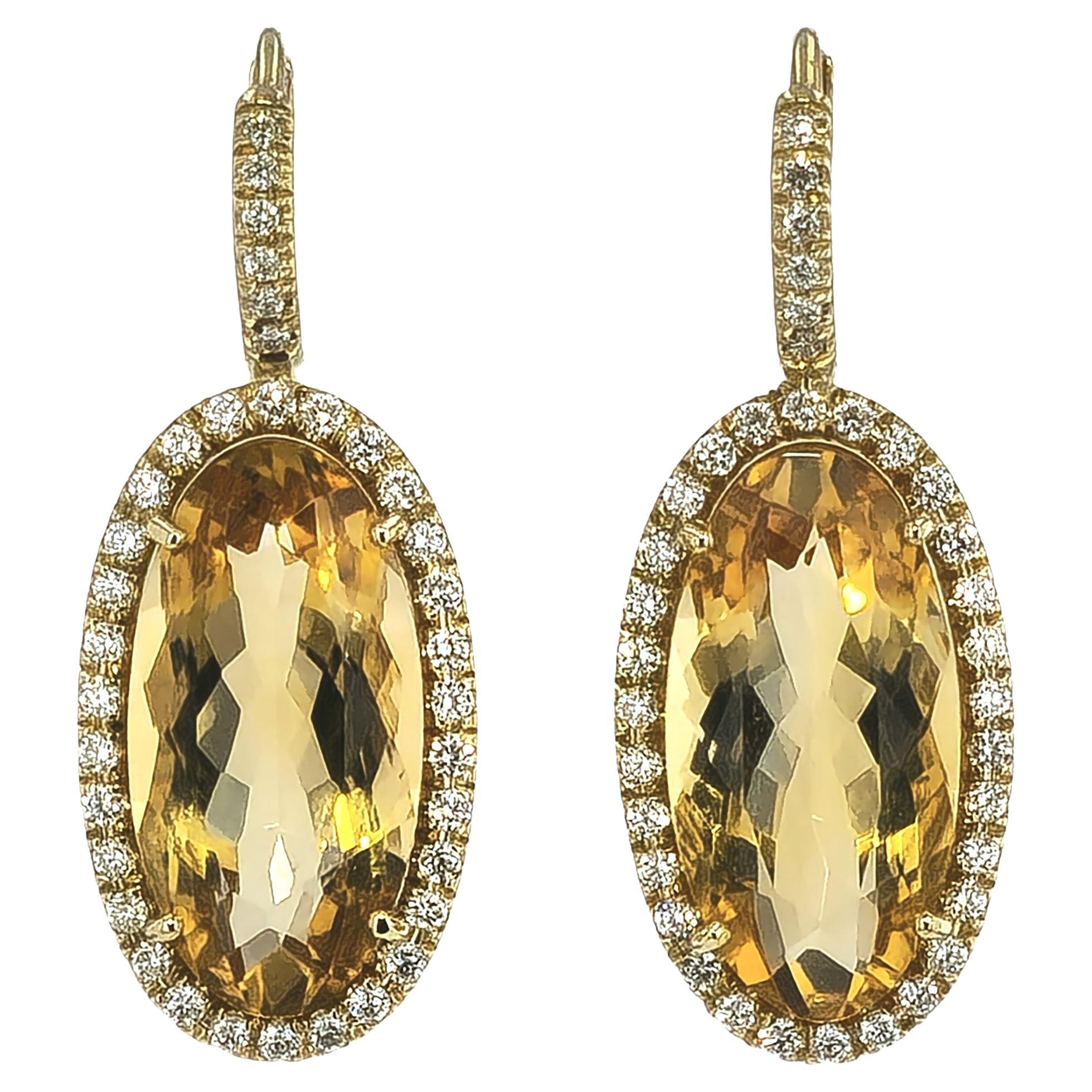 Draw attention to all the right places with these magnificent Elongated Oval Citrine Diamond Pave Drop Earrings. Handcrafted H&H Collection in 18 karat yellow gold, the earrings feature an elongated oval-shaped citrine centerpiece, surrounded by a