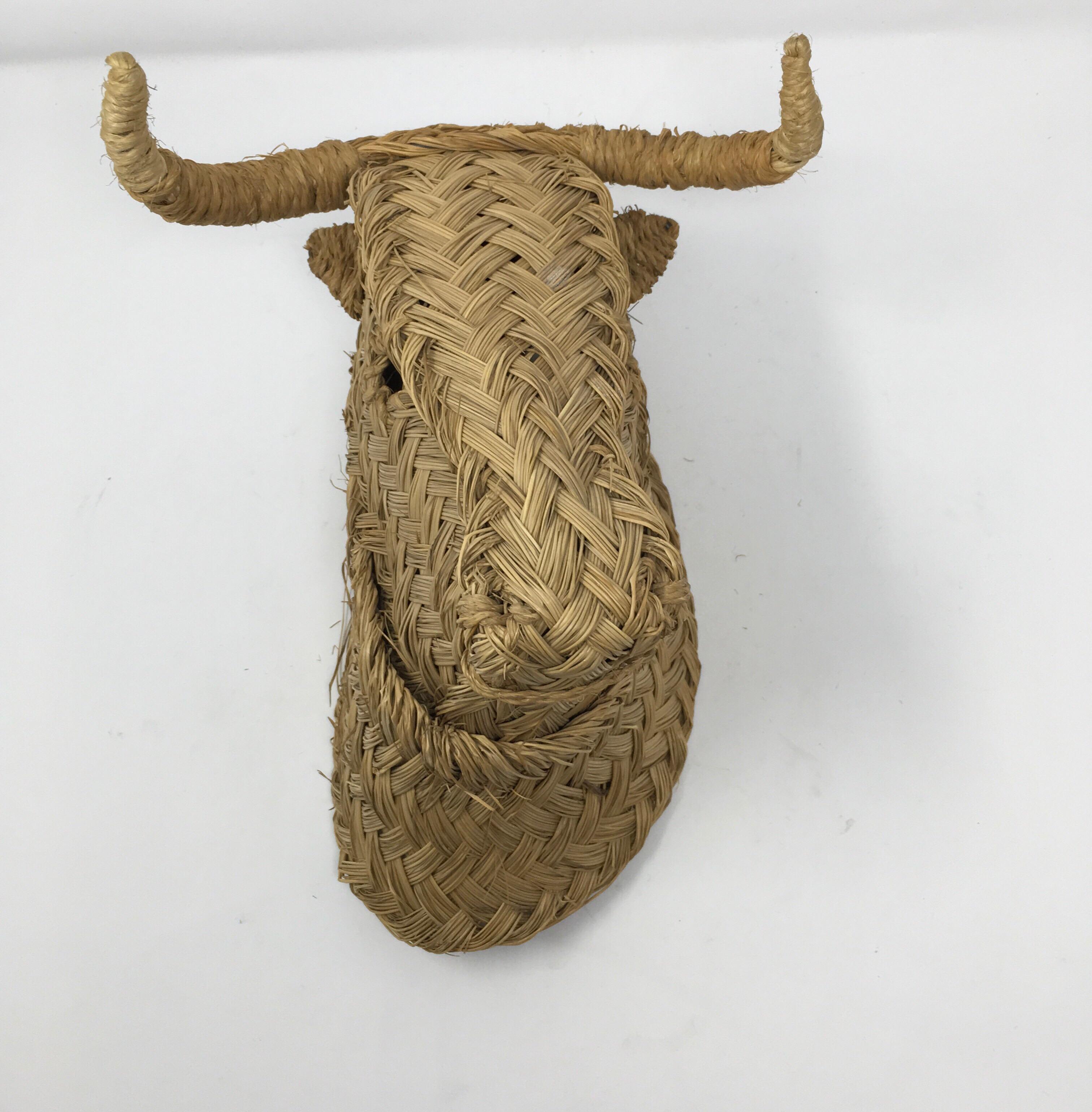 This charming, woven bulls head was handmade in Spain of esparto grass. It would look great at the end of a hallway, above a range or mixed in with other art on a gallery wall. These types of animal heads have been handwoven in Spain, since the
