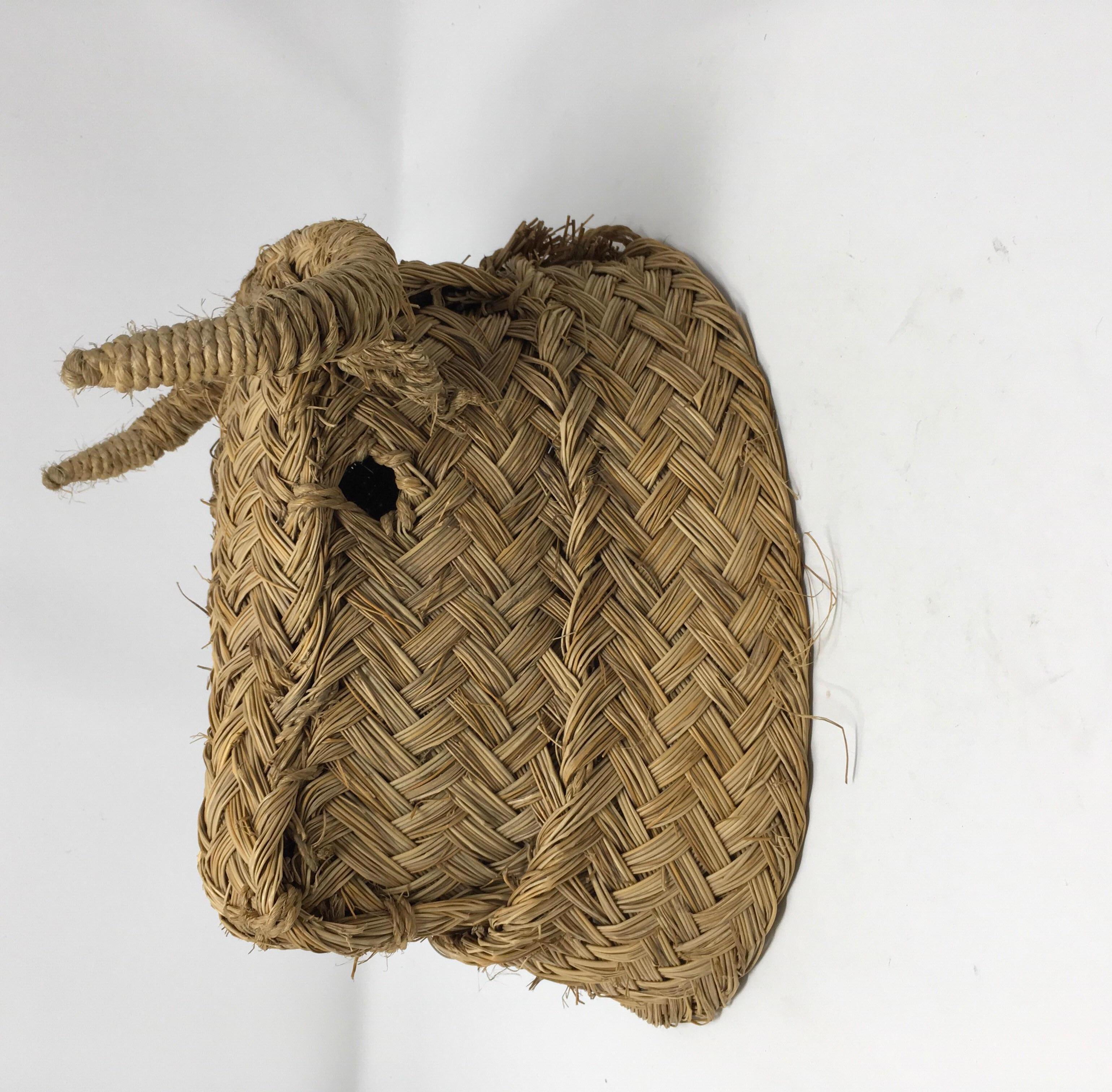 This charming, woven bulls head was handmade in Spain of esparto grass. It would look great at the end of a hallway, above a range or mixed in with other art on a gallery wall. These types of animal heads have been handwoven in Spain, since the