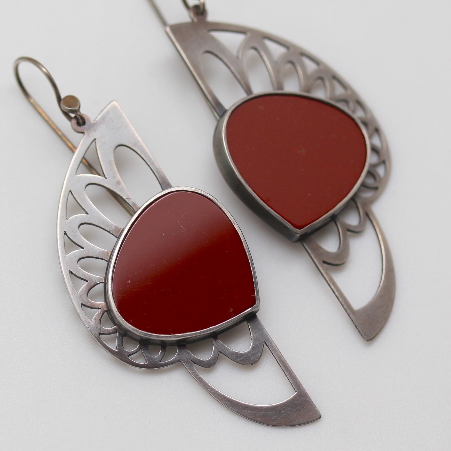 The lyrical movement of a line is captured in these fan like earrings. The Warrior Earrings by Metaalia Jewelry are bold statement earrings, large and in-charge! Laser cut in NYC, the oxidized sterling has a matte finish and the brick red jaspers