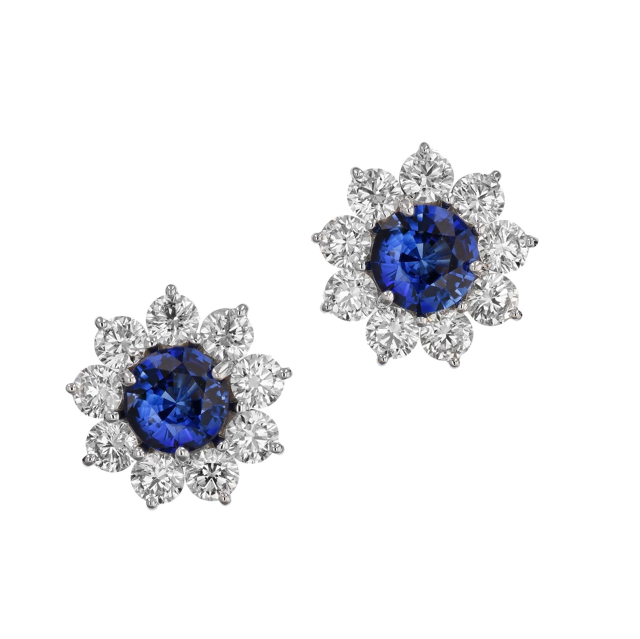 Fall in love with this breathtaking sparkle of Fine Blue Sapphire and Diamond Stud Earrings, handcrafted in luxurious 18 karat white gold.

Fine Blue Sapphire create a majestic centerpiece, and 18 perfectly cut diamonds circle around them for